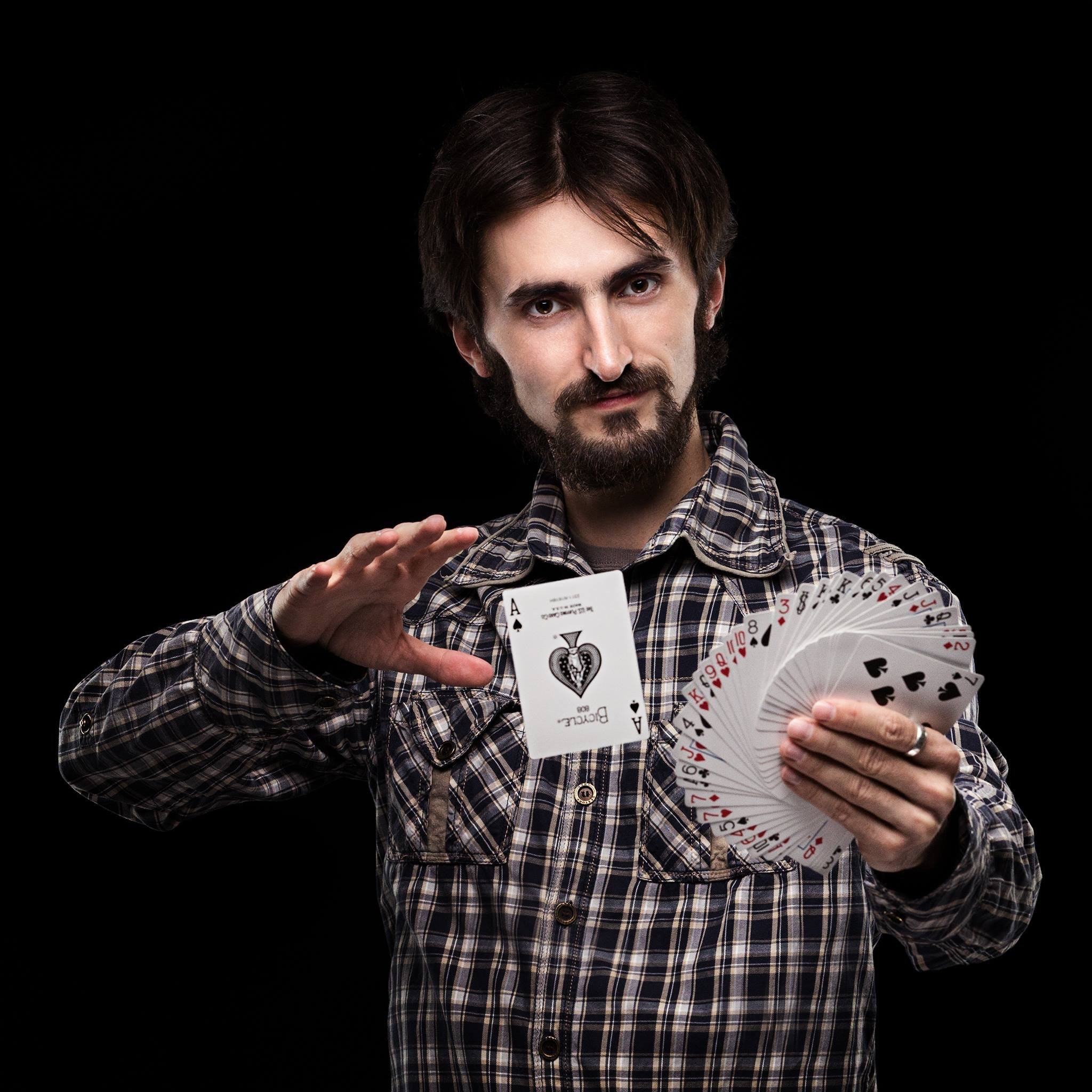 A magician holding up his cards. | Pexels/  Nikolay Ivanov