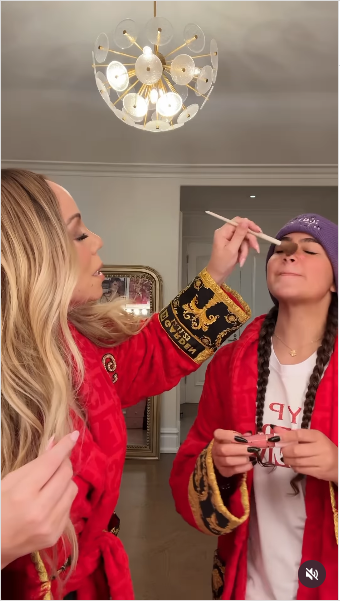 Mariah Carey applying makeup on her daughter Monroe from a video posted on August 5, 2025 | Source: Instagram/mariahcarey