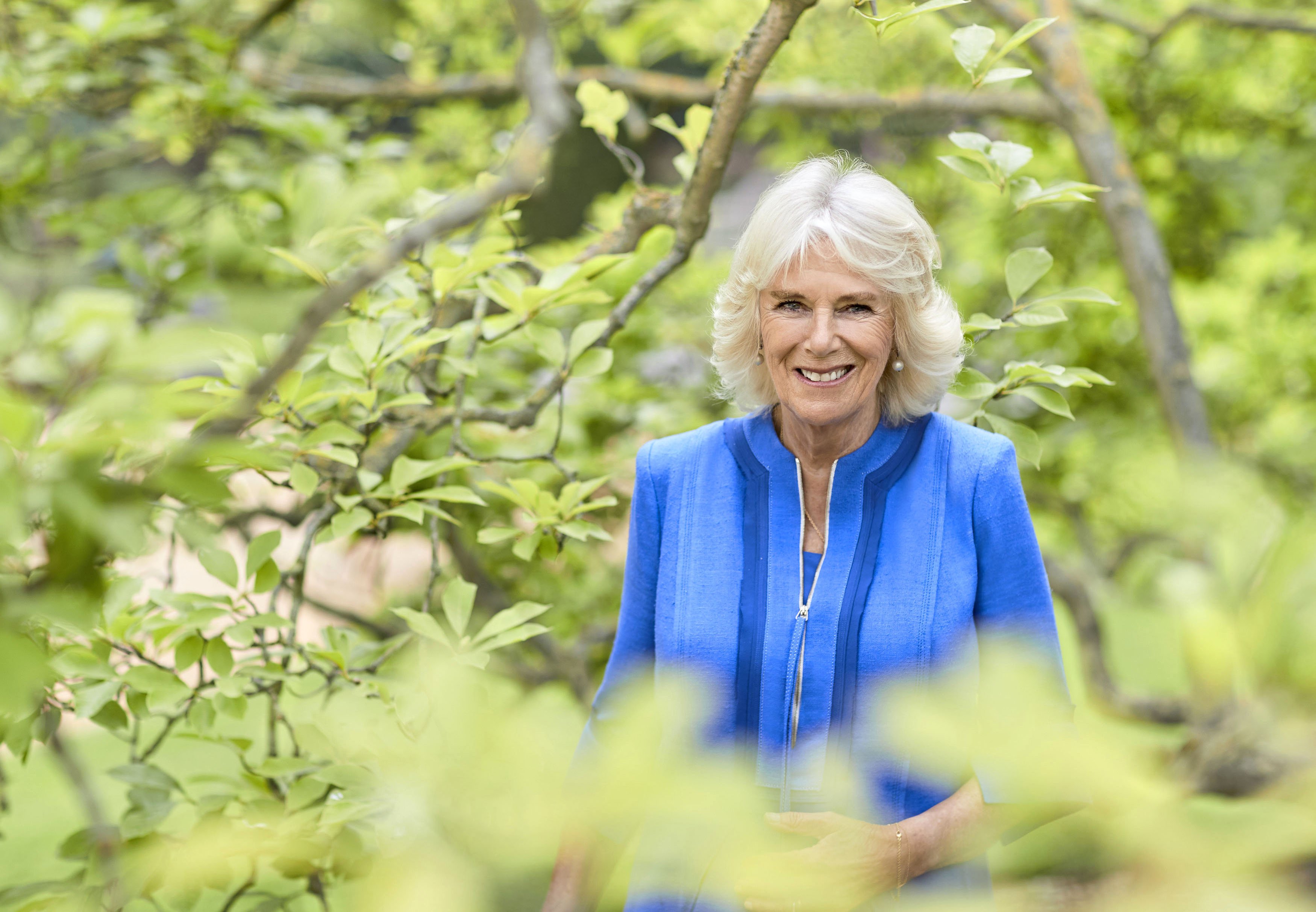 Camilla, Duchess of Cornwall poses for an official portrait in the gardens of Clarence House to mark HRH's 73rd birthday, wearing a blue silk linen on July 17, 2020. Photo: Getty Images
