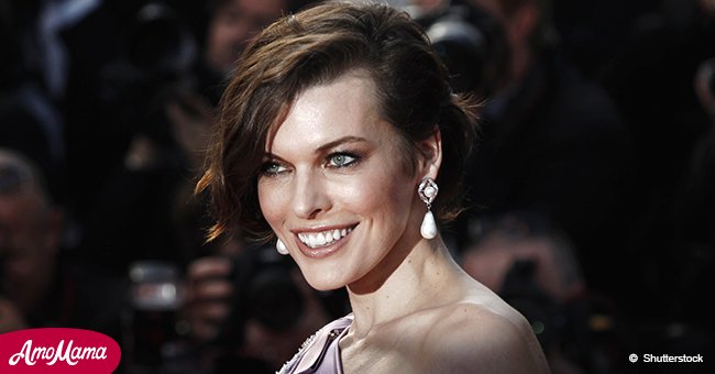 Milla Jovovich shows off her slender figure in a plunging gown at the premiere of 'Burning'