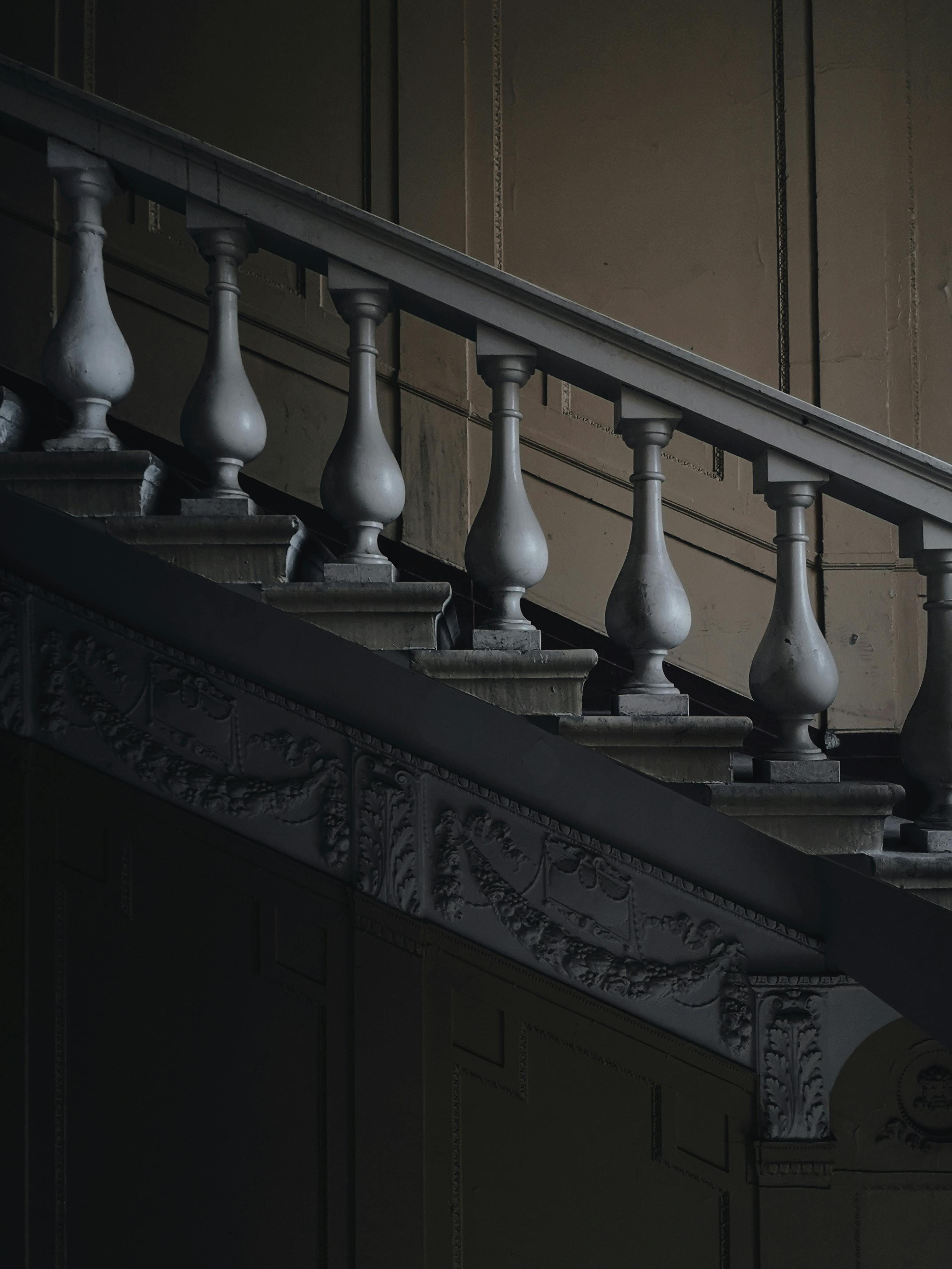 Emma quietly descends the stairs at night, sensing something is amiss | Source: Pexels
