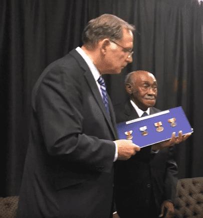 US Senator John Boozman holding the medals before presenting it to the World War II veteran, Thomas Franklin Vaughns. | Source: YouTube/ArkansasOnline