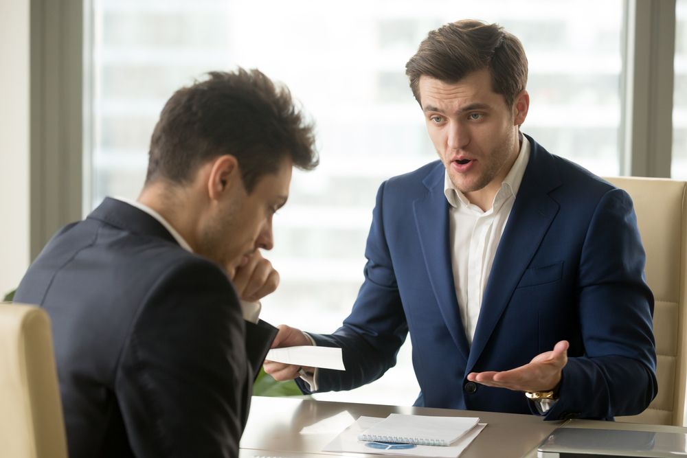 A man talking to a business professional | Source: Shutterstock