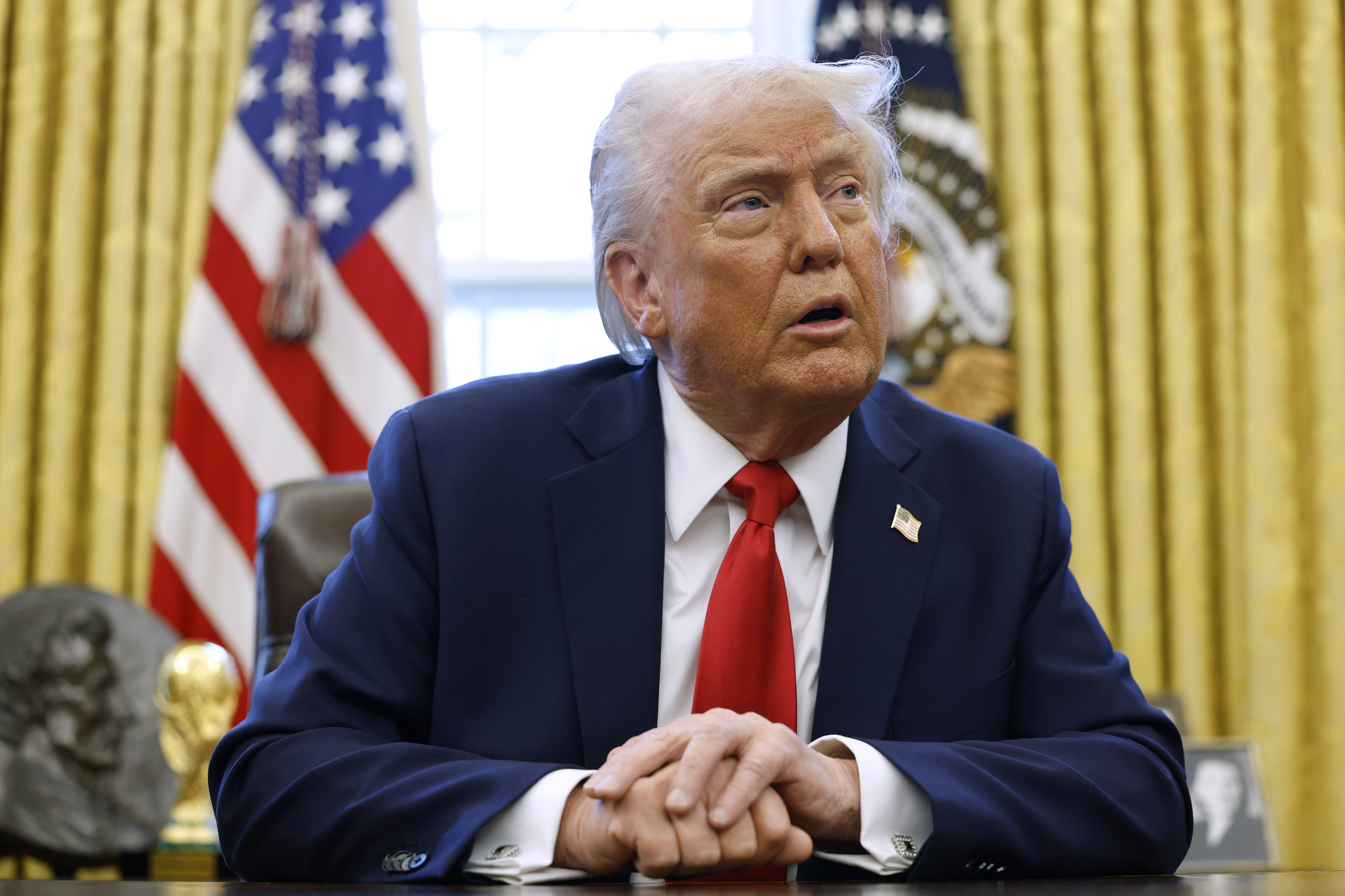 President Donald Trump speaks to reporters in the Oval Office of the White House on February 3, 2025, in Washington, DC | Source: Getty Images