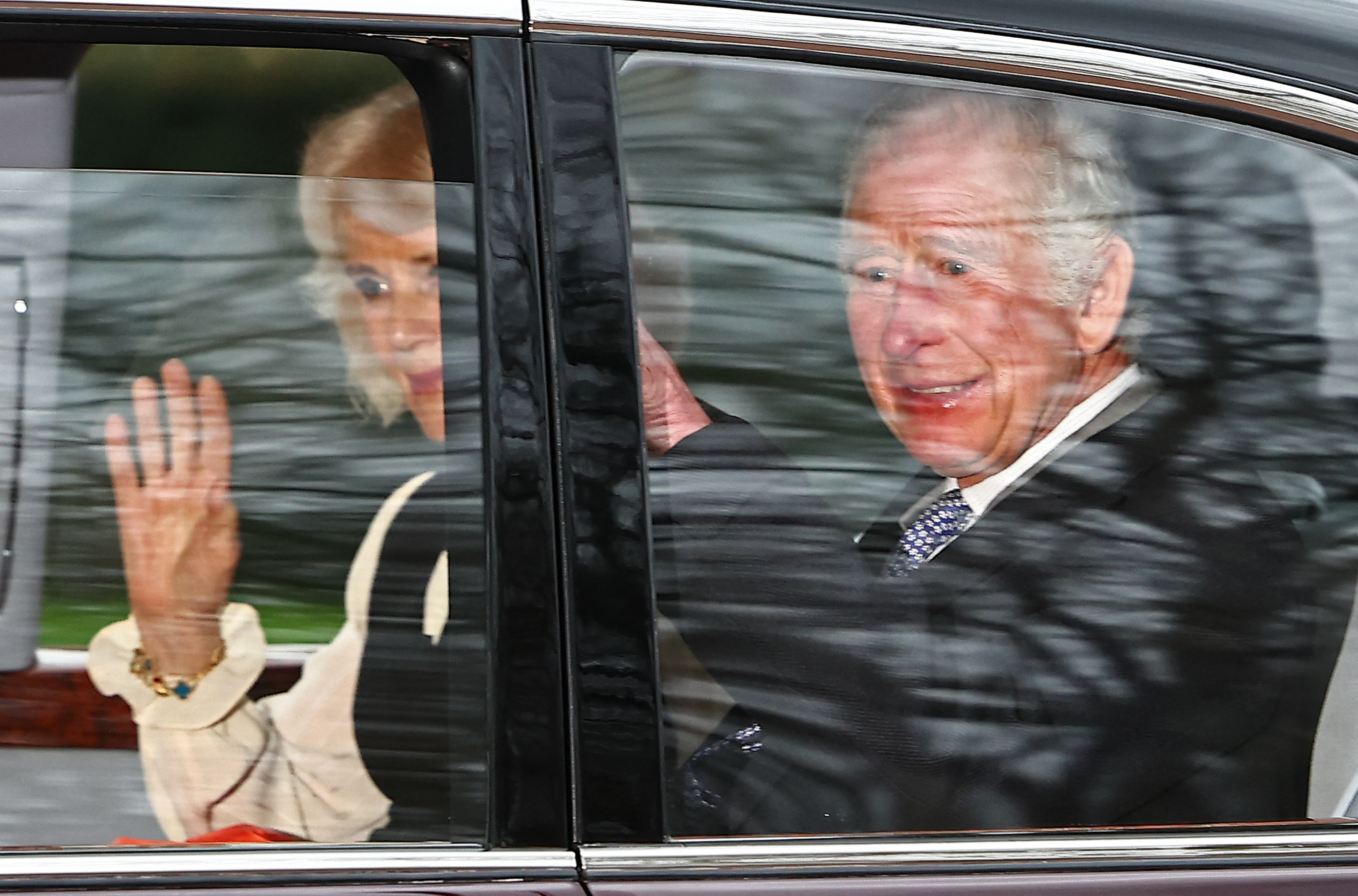 Queen Camilla and King Charles III wave as they leave by car from Clarence House on February 6, 2024 in London. | Source: Getty Images