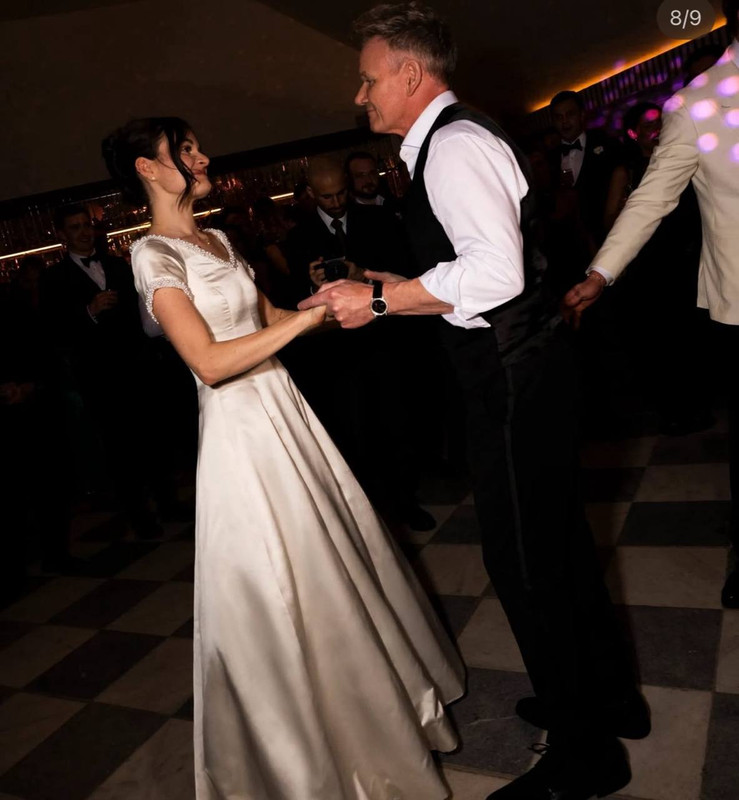 Holly Ramsay and Gordon Ramsay shared a joyful father-daughter dance during the evening celebrations. Now changed into her mother Tana Ramsay's original wedding dress from the 1990s, Holly looked effortlessly graceful as she twirled across the checkered dance floor. The classic satin gown, with its subtle sheen and delicate cap sleeves, brought a touch of family history to the modern festivities. | Source: Instagram/britishvogue