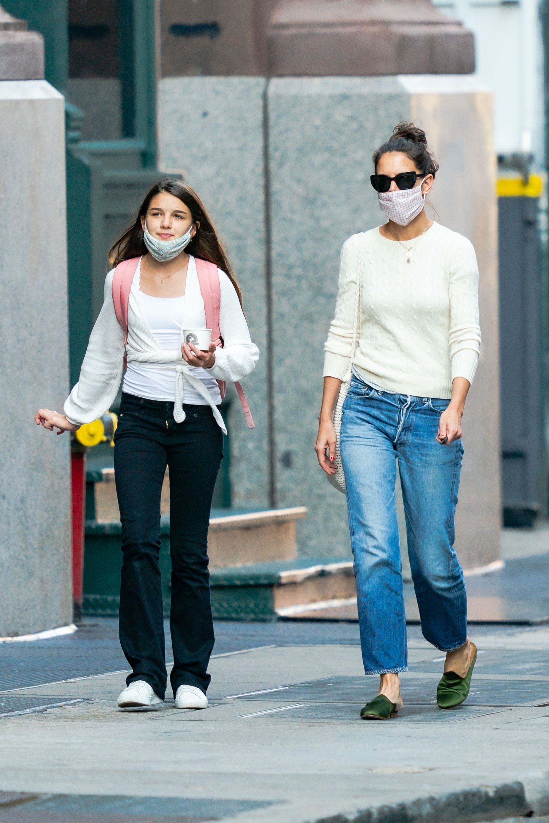 Suri Cruise and Katie Holmes wear face masks while walking together during an outing in New York City. | Source: Getty Images