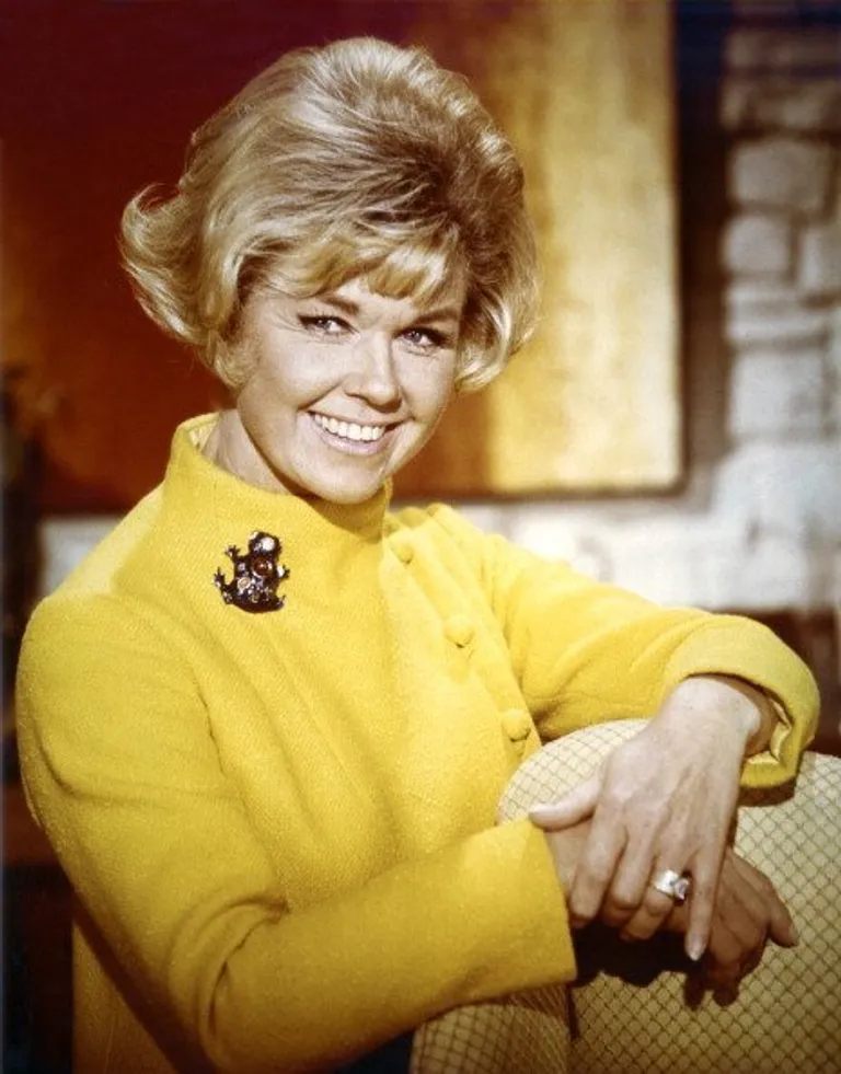 Portrait of Doris Day in a yellow high-neck jacket, with a brooch on the right shoulder circa 1965. | Source: Getty Images