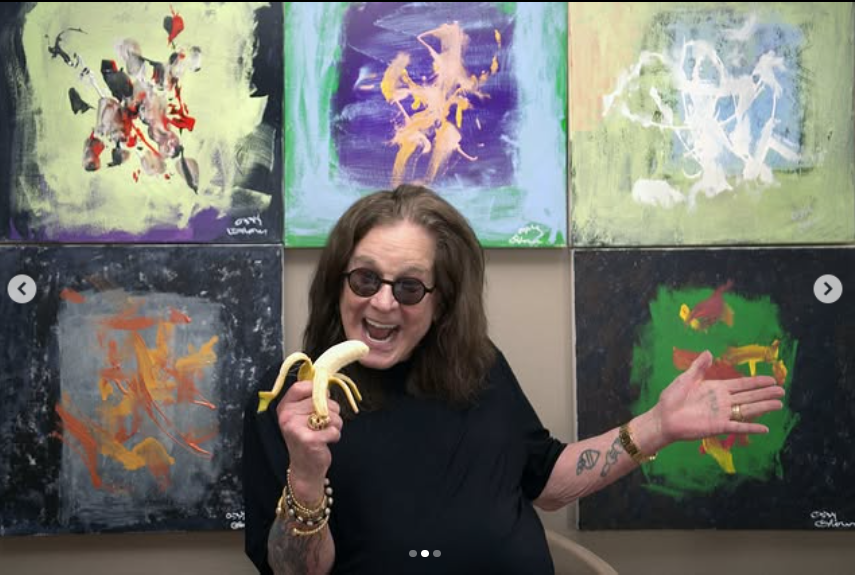 Ozzy Osbourne take picture in front of a wall of art pieces while dressed in his signature black T-shirt and holding a banana, from a post dated July 10, 2025 | Source: Instagram/ozzyosbourne