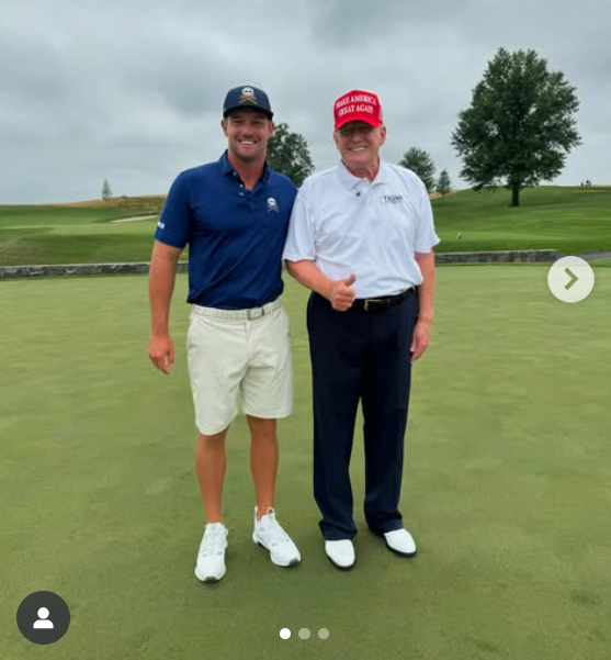 On July 23, Donald Trump stands beside golfer Bryson DeChambeau at Trump National Golf Club in Bedminster. He wears his red cap and a tucked-in white polo, smiling under a cloudy sky with his face looking flushed, while his neck and hands appear much lighter. | Source: Instagram/trumpgolf