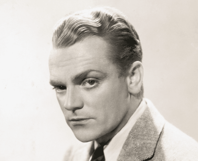 An undated image of James Cagney wearing a suit while seated slightly to the side in the 1920s | Photo: Getty Images