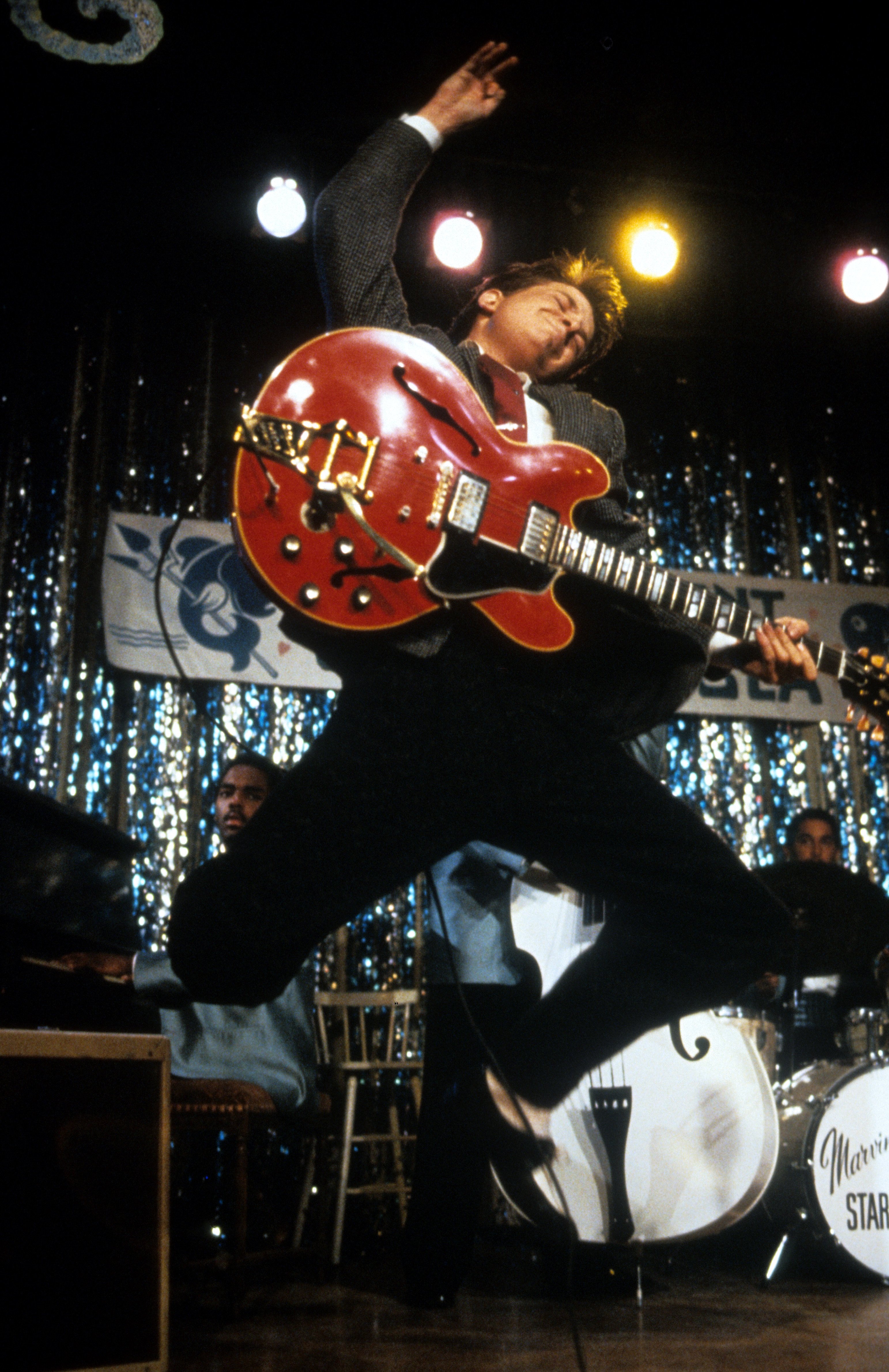 Michael J Fox leaping in air with guitar in a scene from the film 'Back To The Future', 1985. | Source: Getty Images