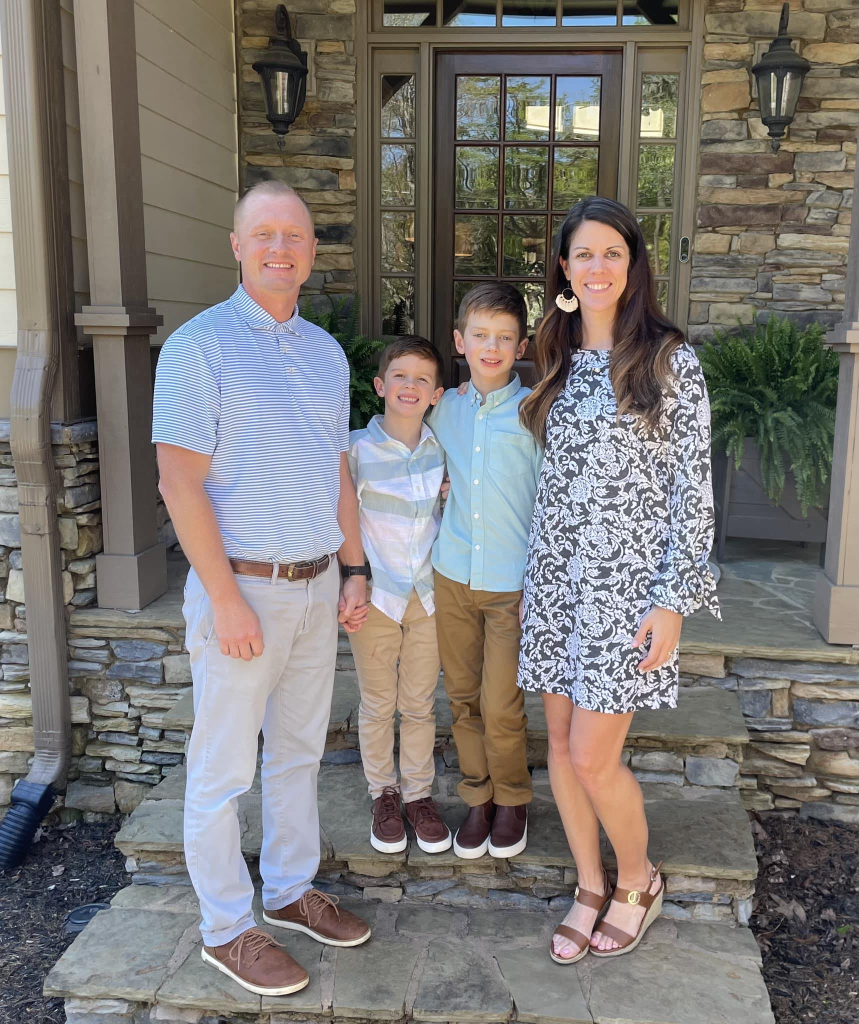Jason, Laura, and their sons, Owen and Luke Hughes, posing on a pier, from a post dated  August 11, 2023 | Source: Facebook/Laura Palmer Hughes