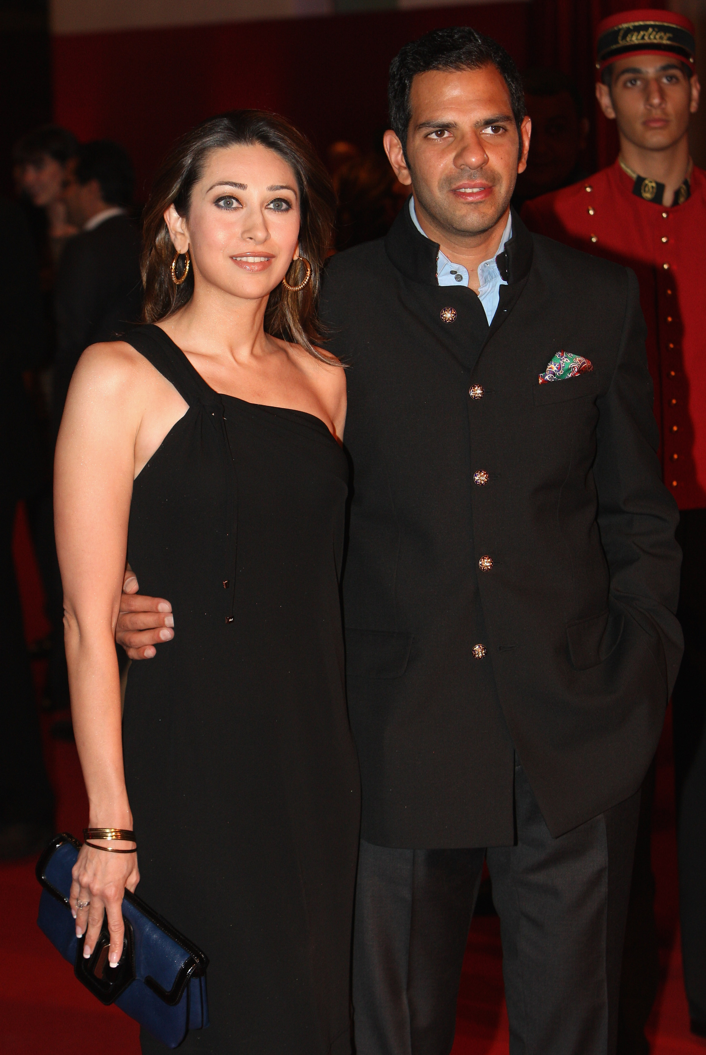 Sanjay Kapur and Karisma Kapoor pose for a photograph during the inauguration of the new Cartier Boutique at Dubai Mall on March 26, 2009, in United Arab Emirates | Source: Getty Images