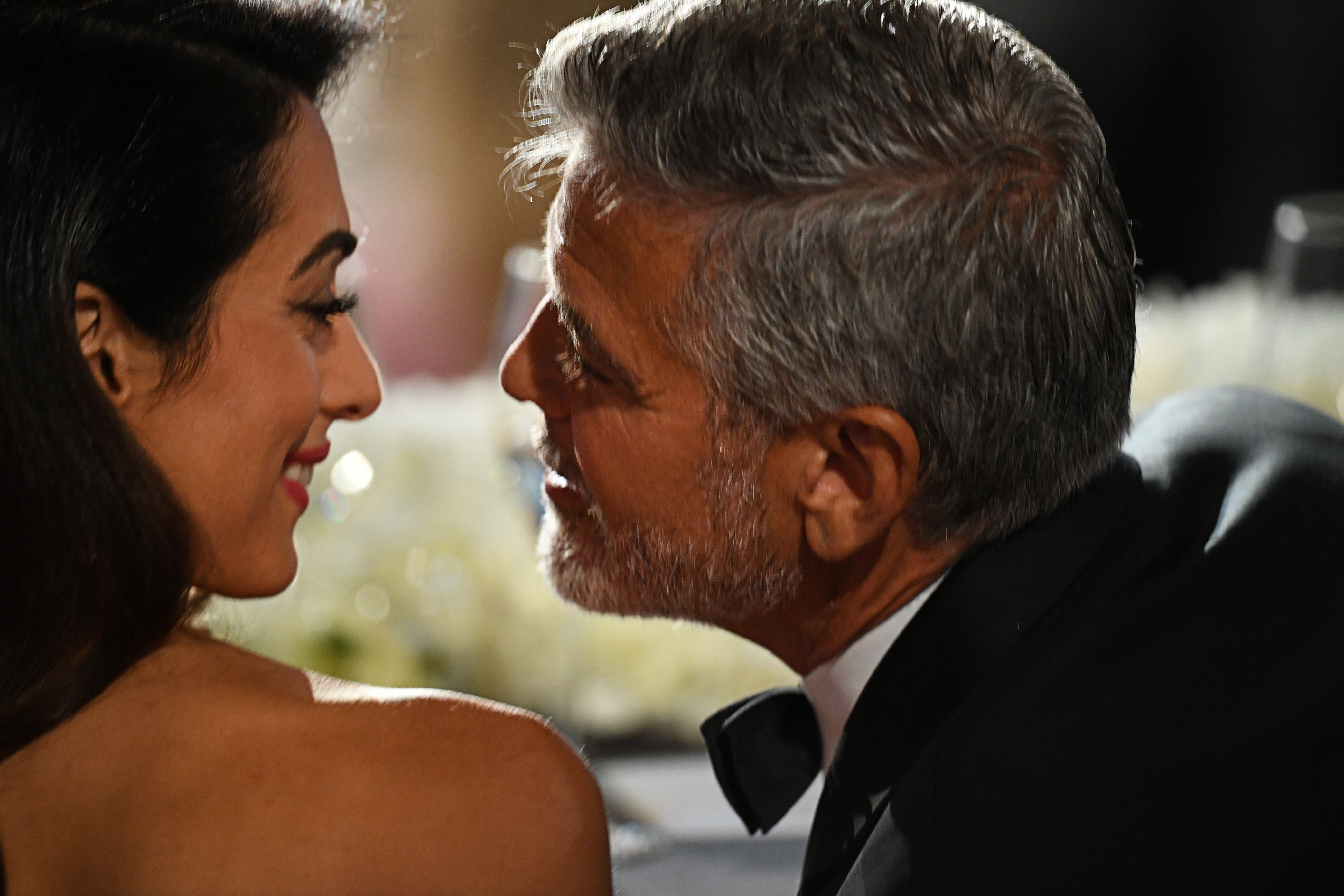 Amal and George Clooney sharing a loving moment during the 46th Life Achievement Award Gala Tribute to him. | Source: Getty Images