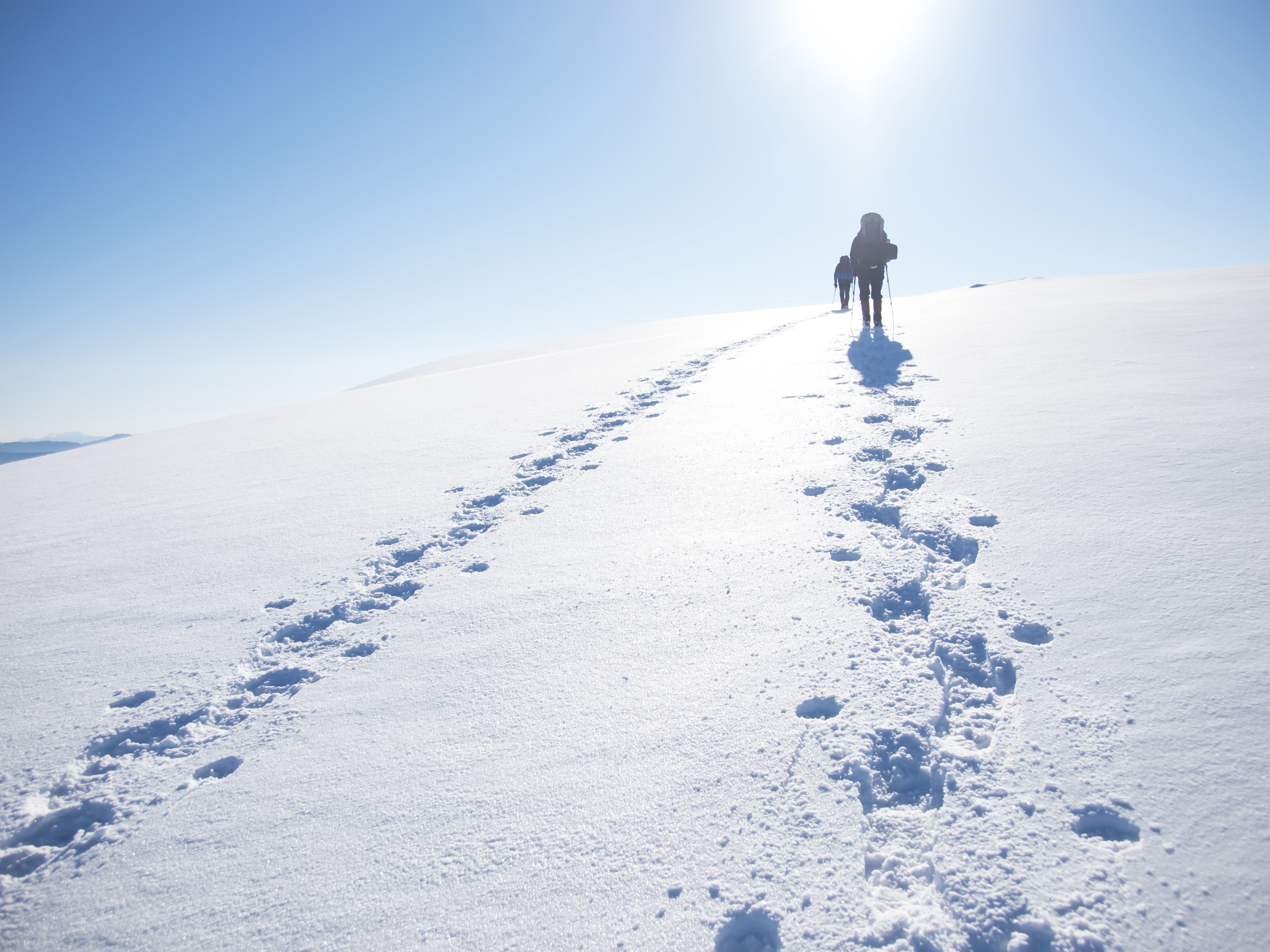 Man walking up a ski slope | Photo: Shutterstock