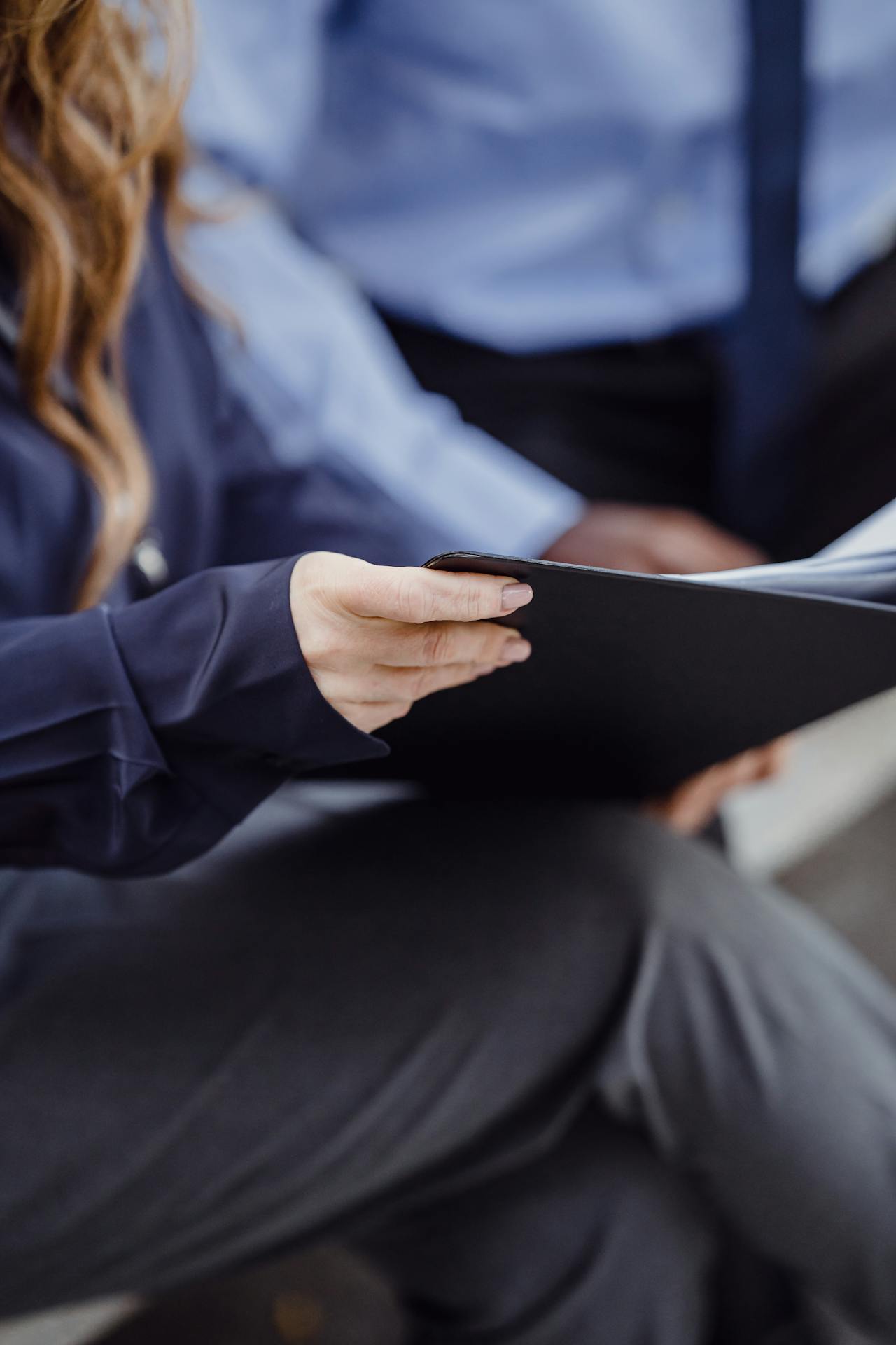 A woman holding a folder with documents | Source: Pexels