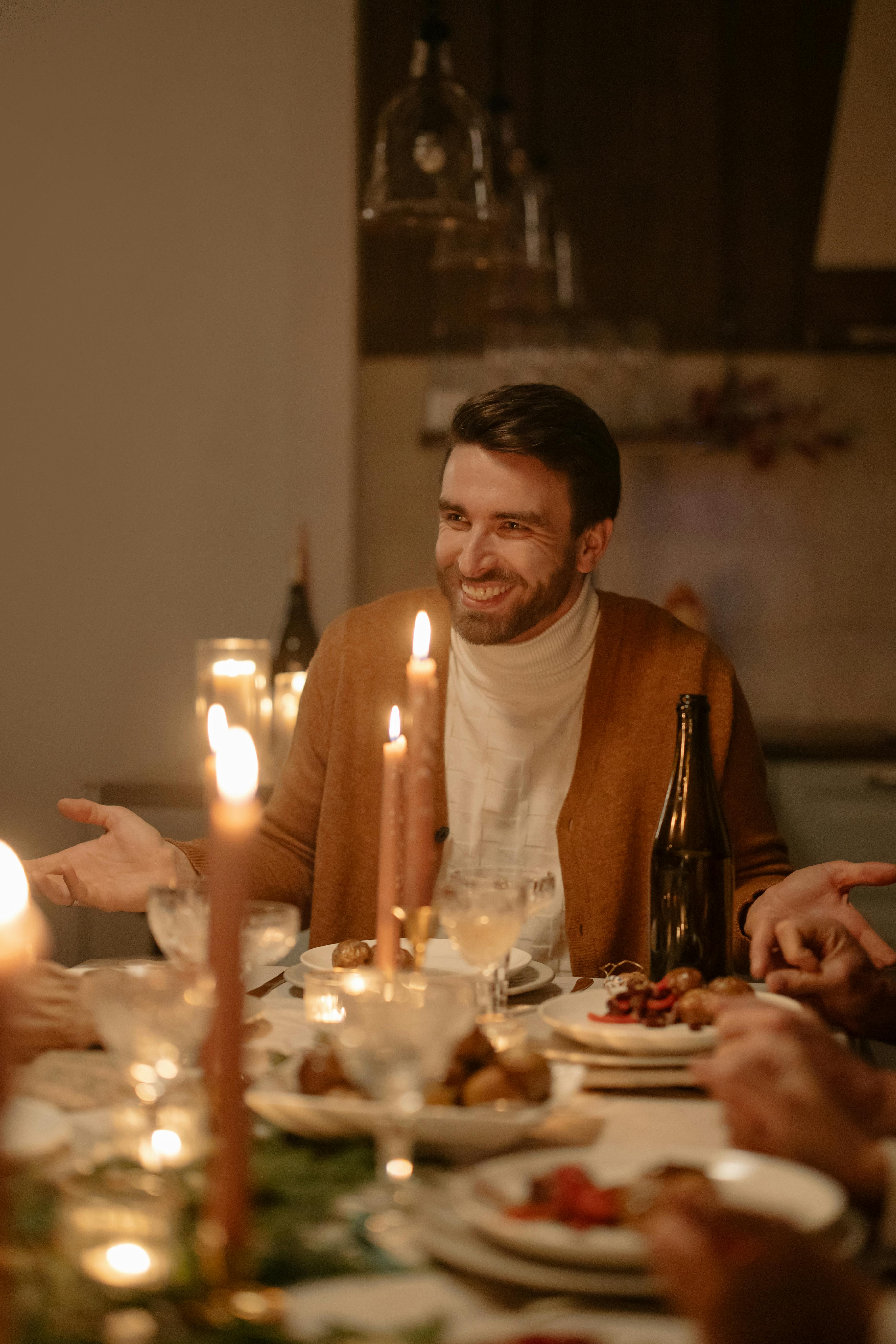 A happy man at the dinner table | Source: Pexels