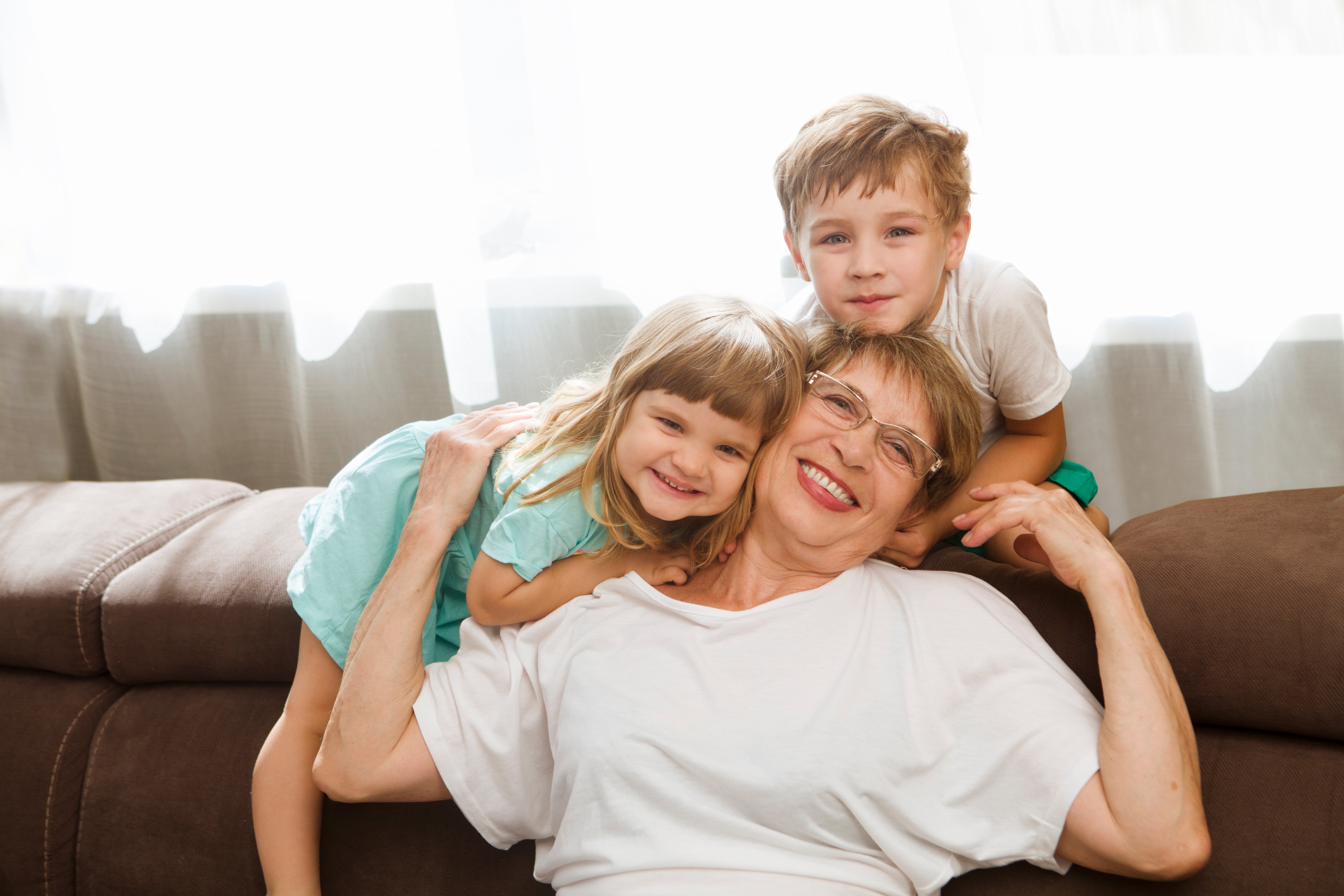 A grandmother looking after her two grandchildren. | Source: Shutterstock.