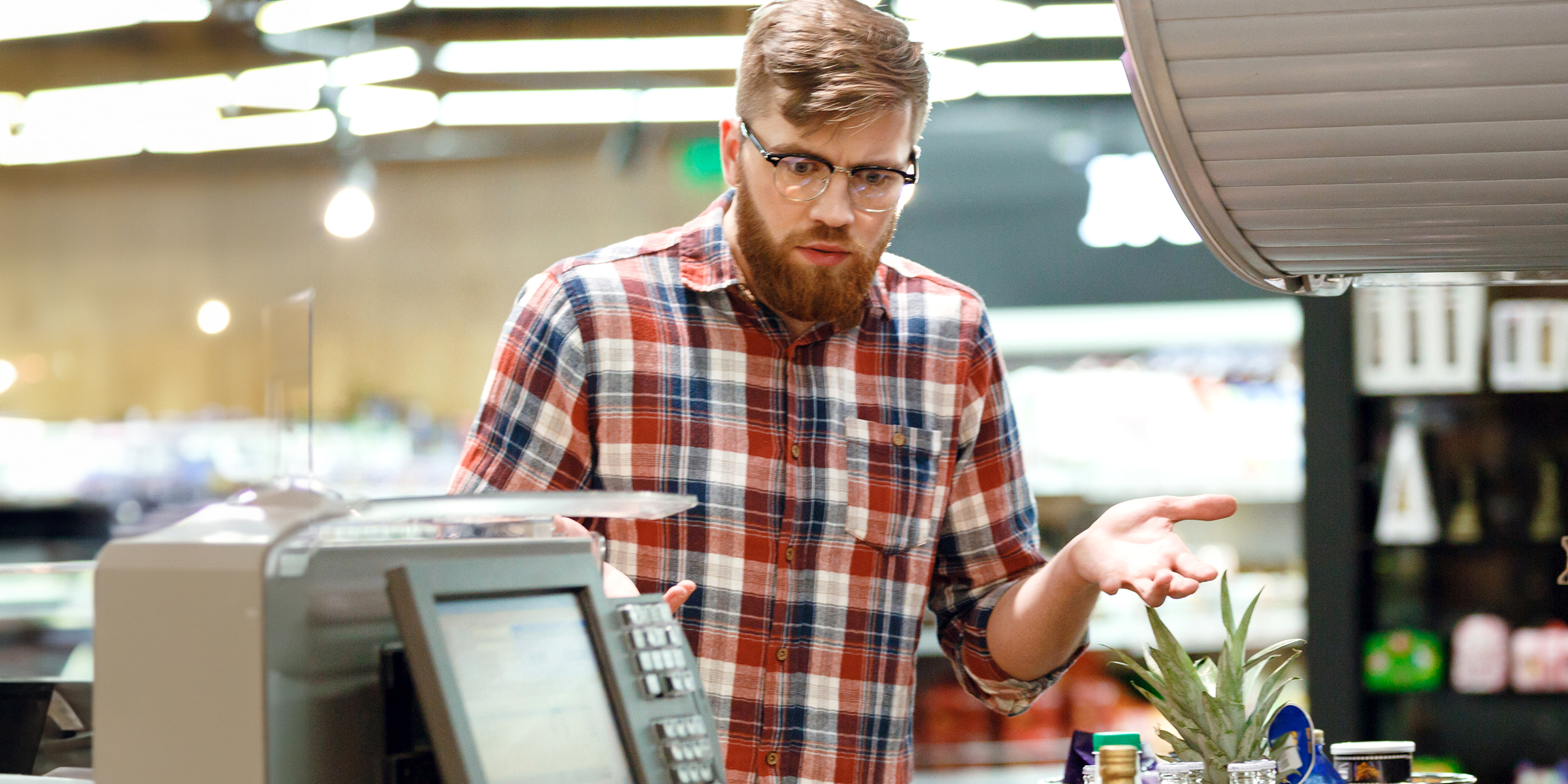 A man standing in front of a cashier | Source: Shutterstock