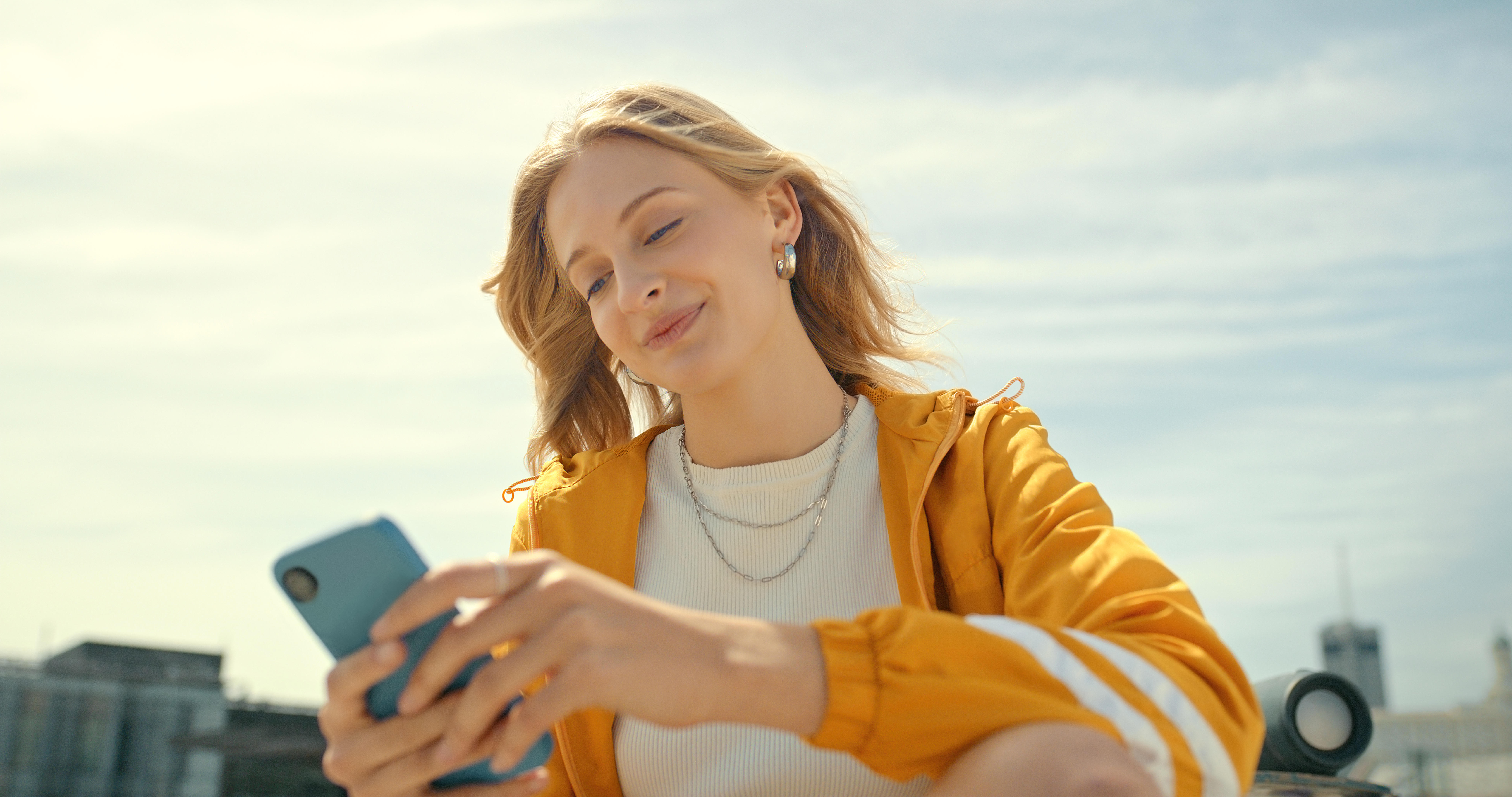 Phone, city and trendy woman on mobile app, chatting or texting for 5g networking, young fashion blog or social media. Streetwear student or gen z person on smartphone, cellphone and internet outdoor | Source: Getty Images