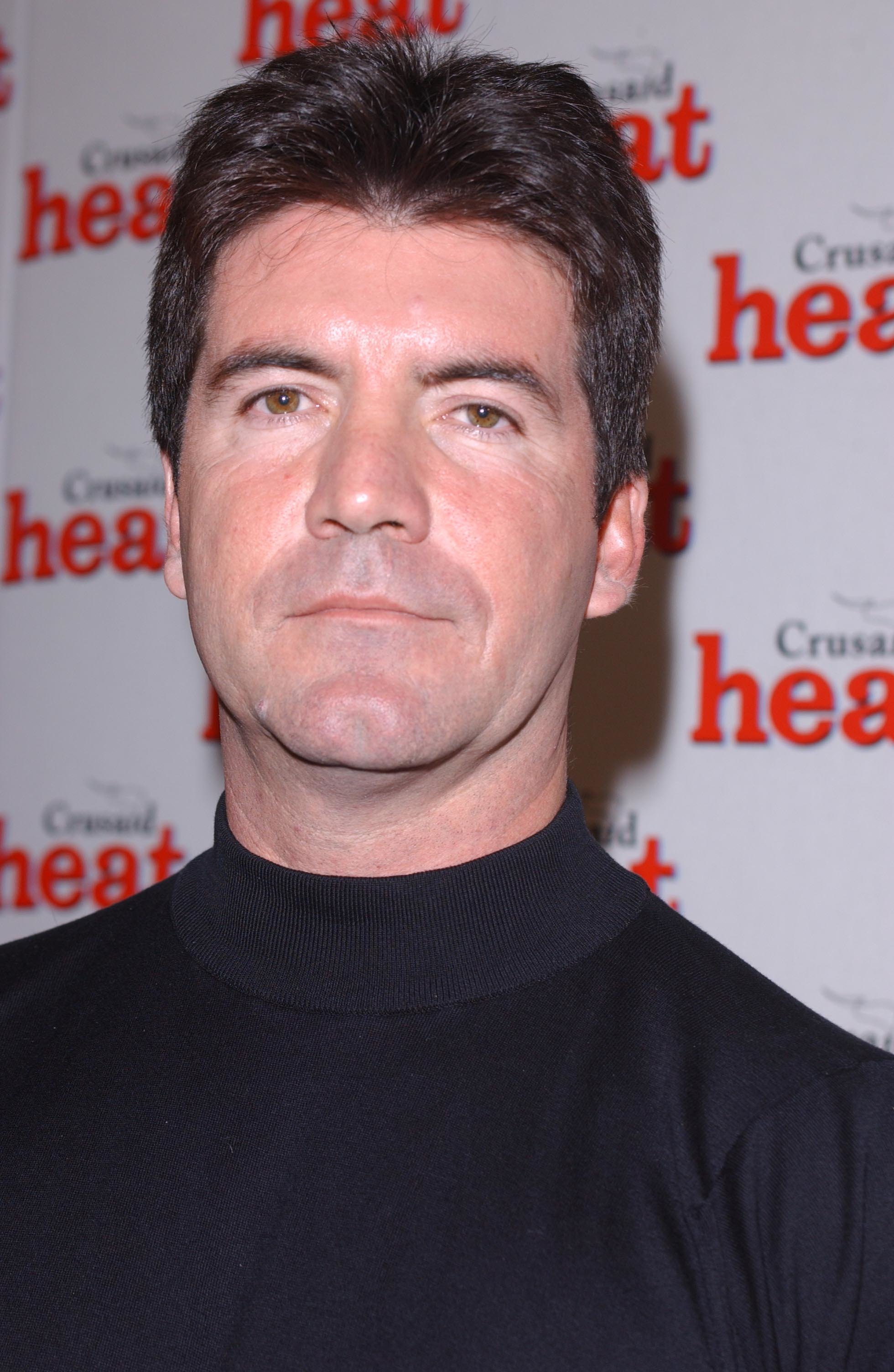 Simon Cowell attends the Heat magazine celebrity auction in London in 2002. | Source: Getty Images