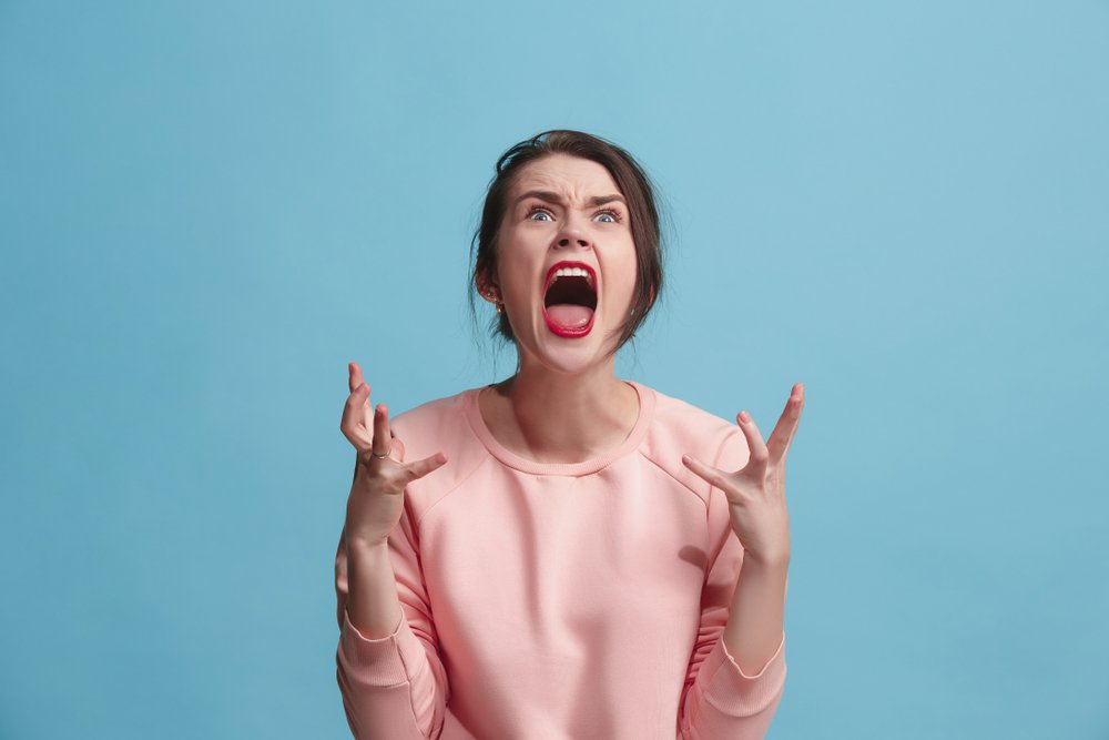 An emotional angry woman screaming. | Photo: Shutterstock.