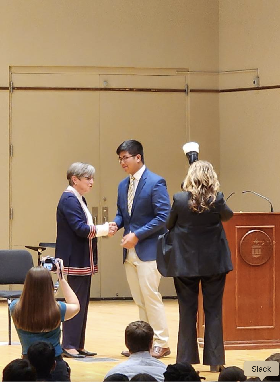 Austin Tran is pictured onstage at Washburn University in Topeka, dated May 6, 2025 | Source: Facebook/Austin Tran is seen at the University of Notre Dam, dated April 6, 2025 | Source: Facebook/anntravels2