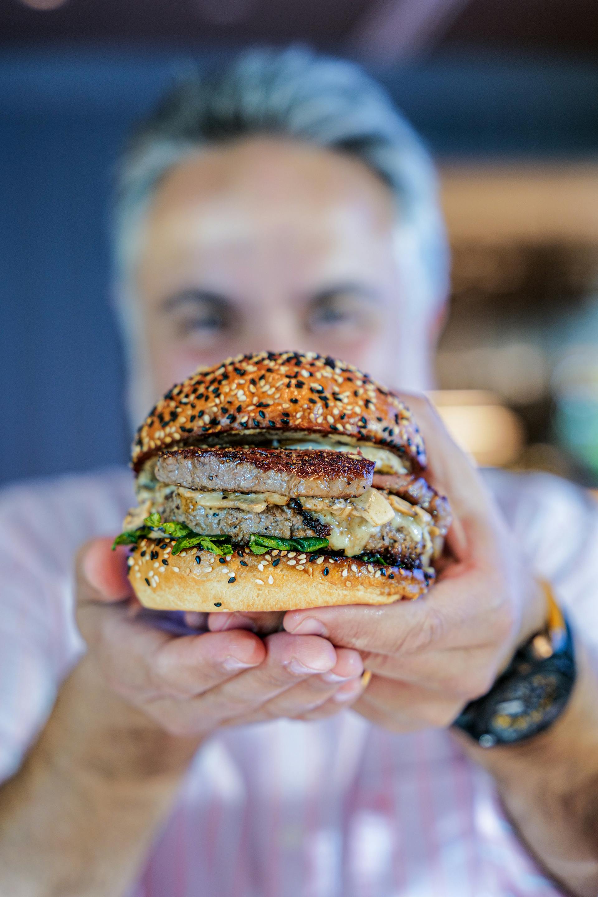 A man holding a hamburger | Source: Pexels