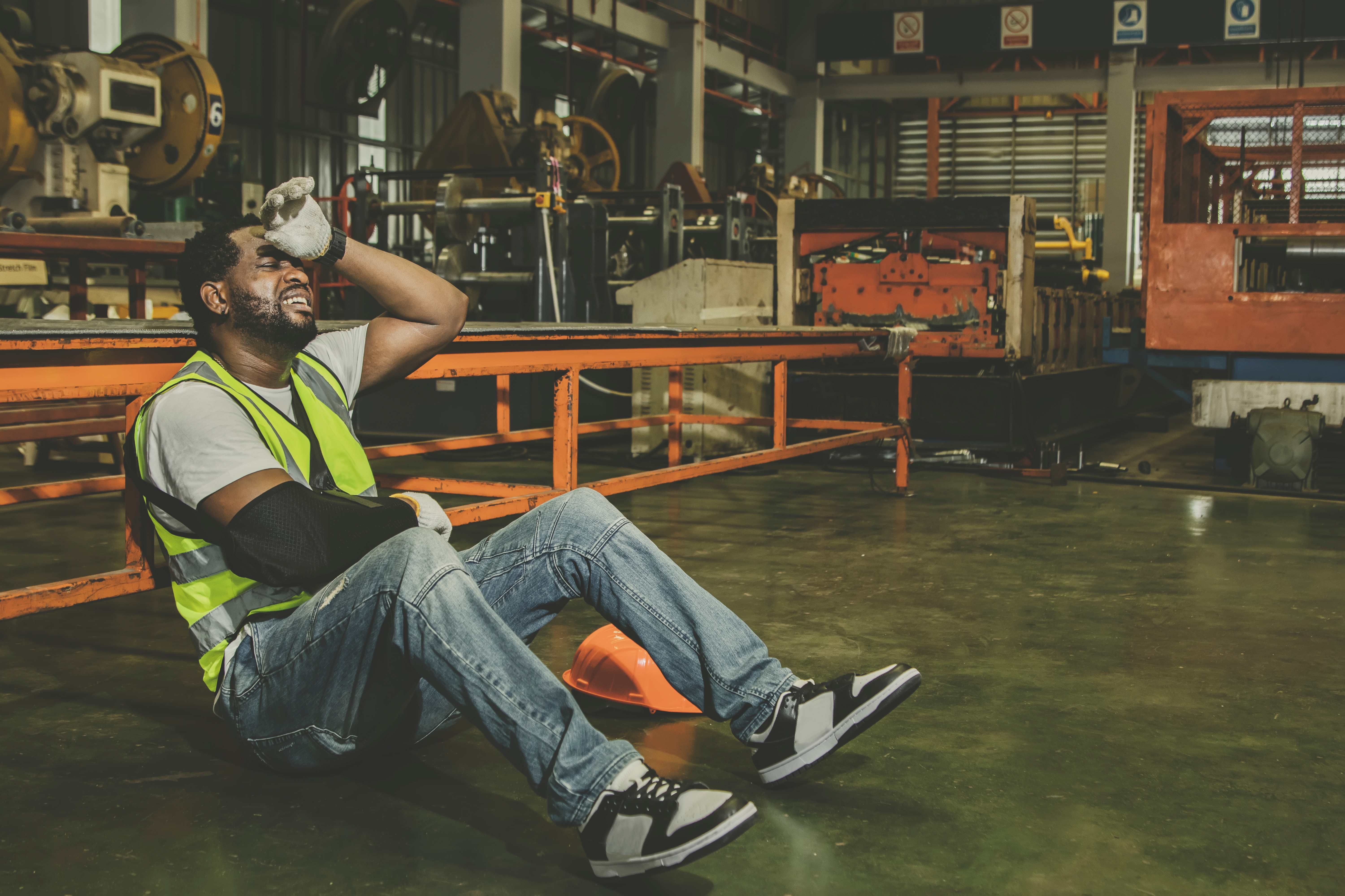 A factory worker sitting on the ground | Source: Shutterstock
