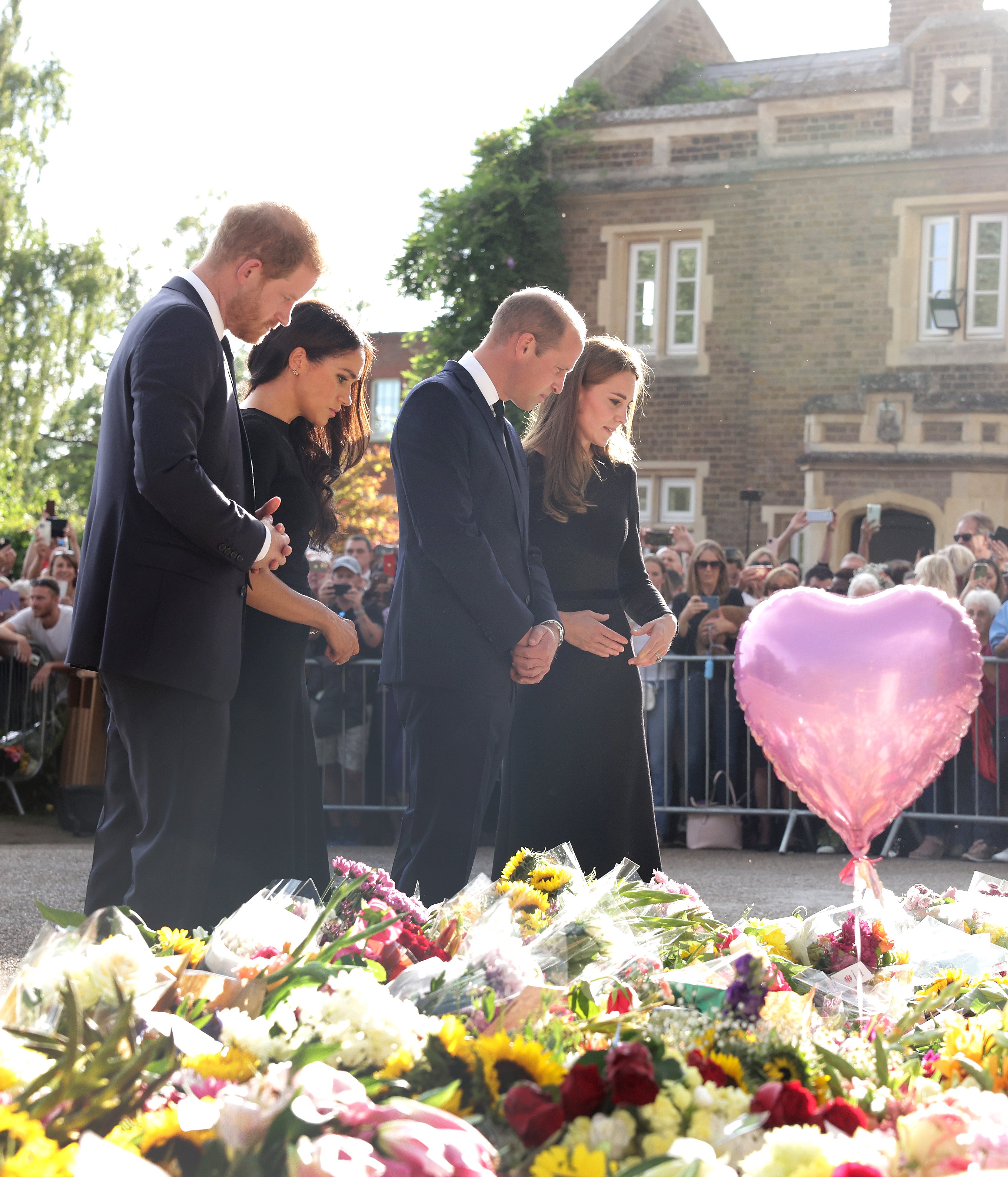 Princess Kate, Prince William, Prince Harry, and Duchess Meghan viewing flowers and tributes to Queen Elizabeth II at Windsor Castle on September 10, 2022, in Windsor, England | Source: Getty Images
