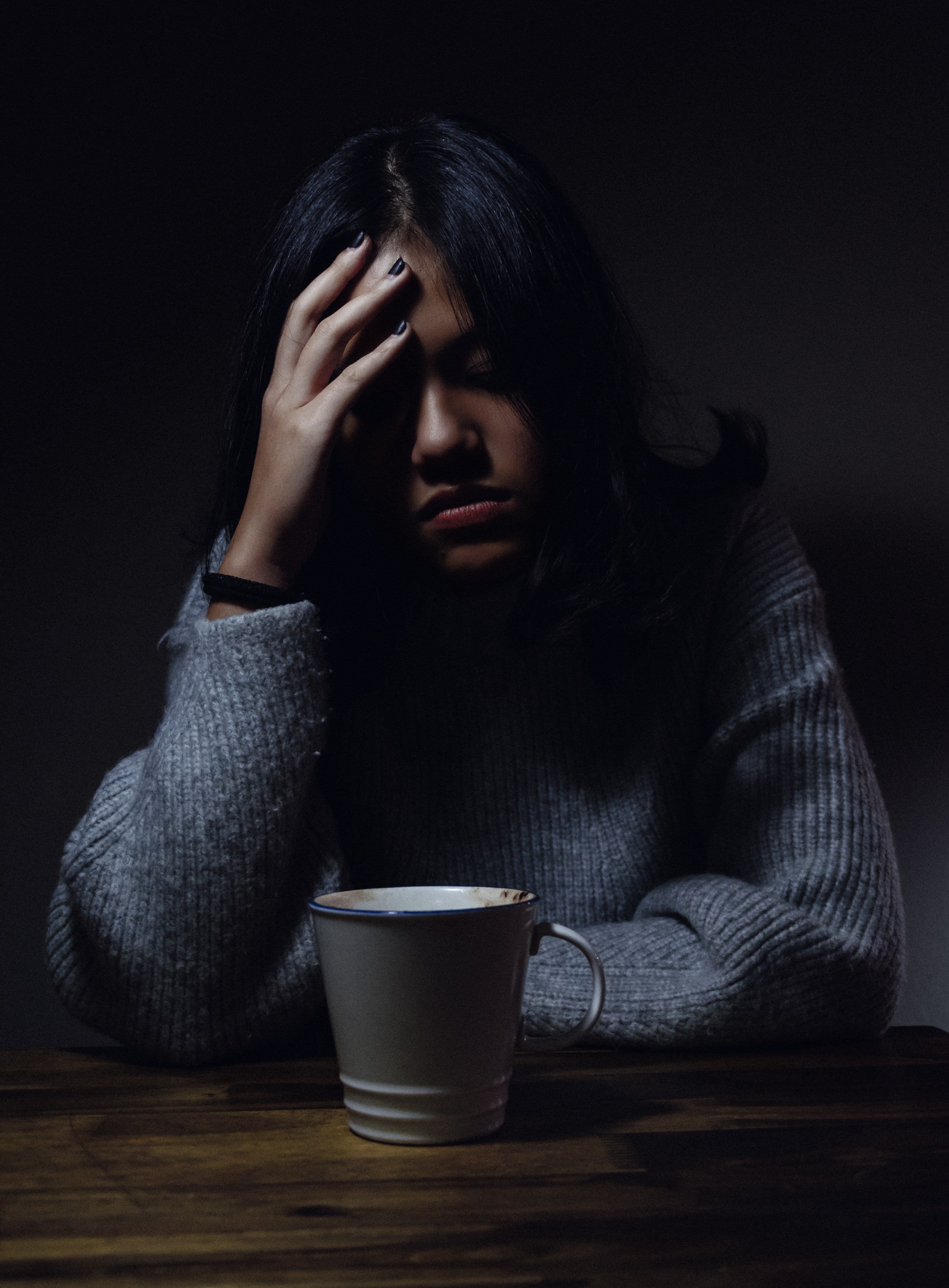 Picture of a sad woman wearing a gray jumper | Source: Unsplash /  Anh Nguyen