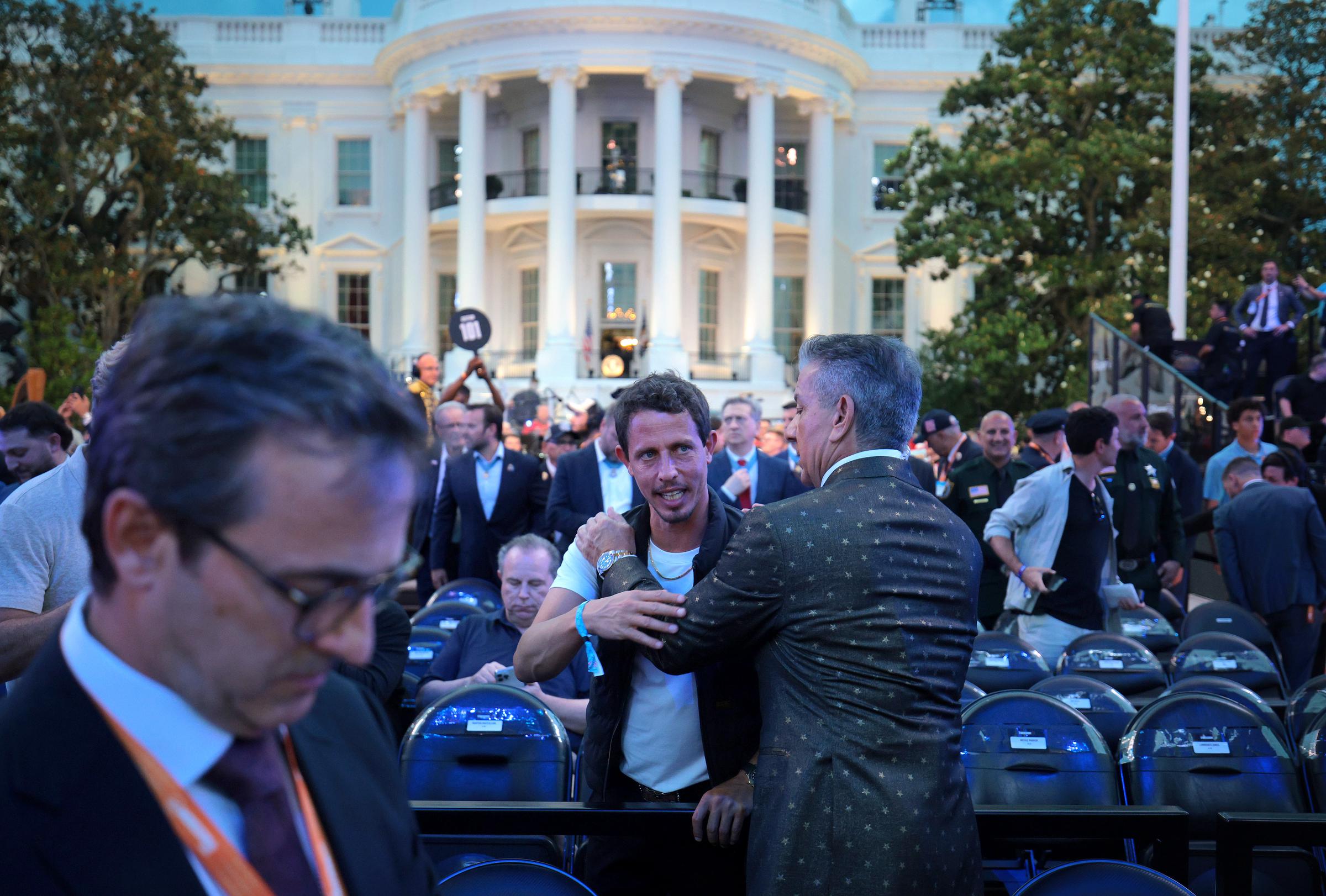 Tony Hinchcliffe greets fellow attendees at the UFC Freedom 250 event on the White House South Lawn. | Source: Getty Images