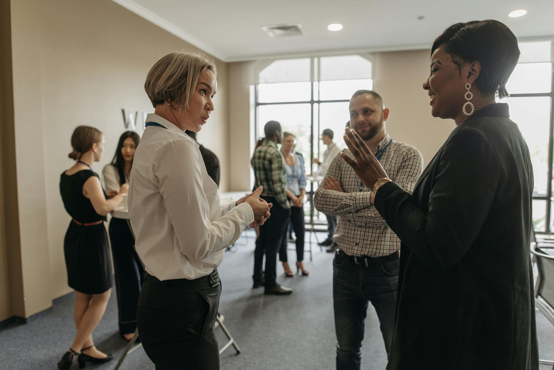 People speaking outside a meeting venue | Source: Pexels