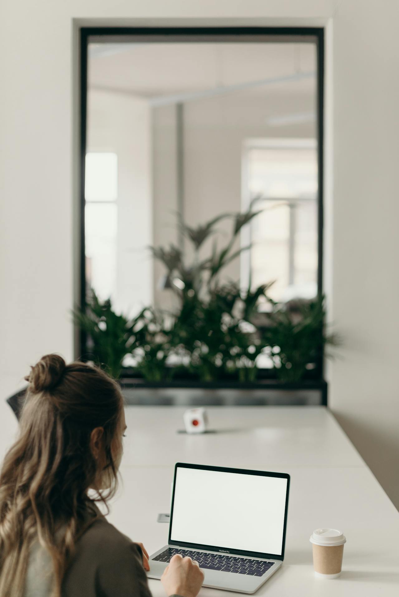A woman using a laptop in her office | Source: Pexels