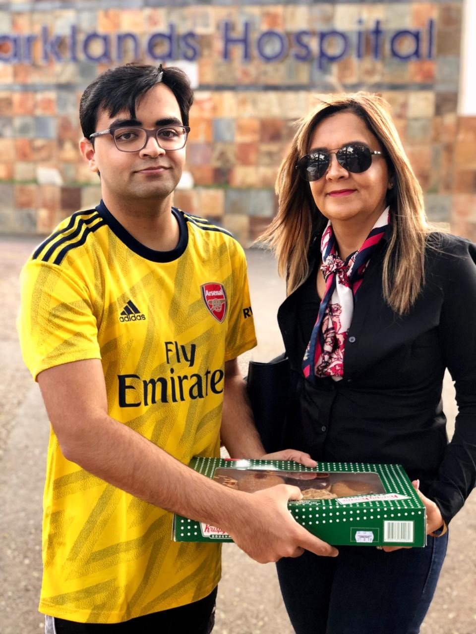 Mariam with her handsome eldest son, Nasser Khan, delivering donuts to Parklands Hospital Radiotherapy Department in August 2019. | Source: Dr. Mariam Seedat Khan