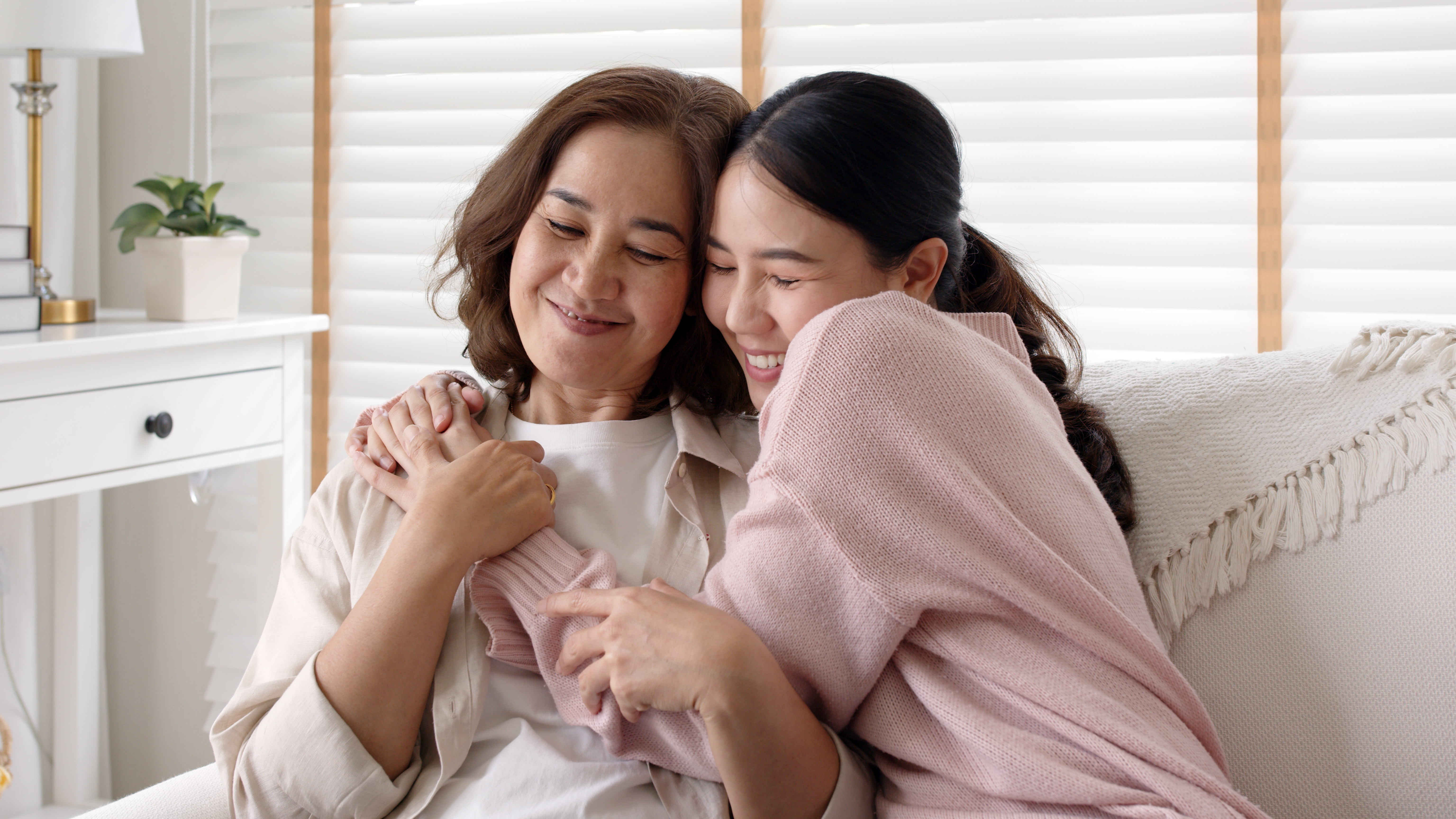 Daughter hugs mom | Shutterstock