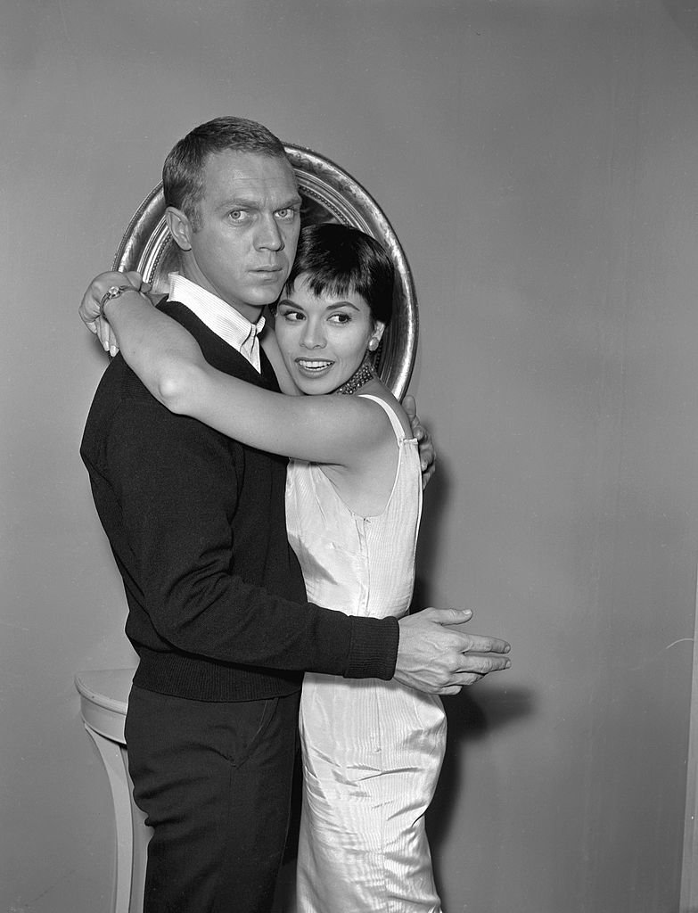 Steve McQueen and Neile Adams embrace during the filming of TV series 'Alfred Hitchcock Presents' entitled 'Man from the South,' on December 23, 1959. | Photo: Getty Images