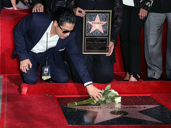 Chris Pérez coloca un ramo de flores en la estrella de Selena en el Paseo de la Fama. Fuente: Getty Images