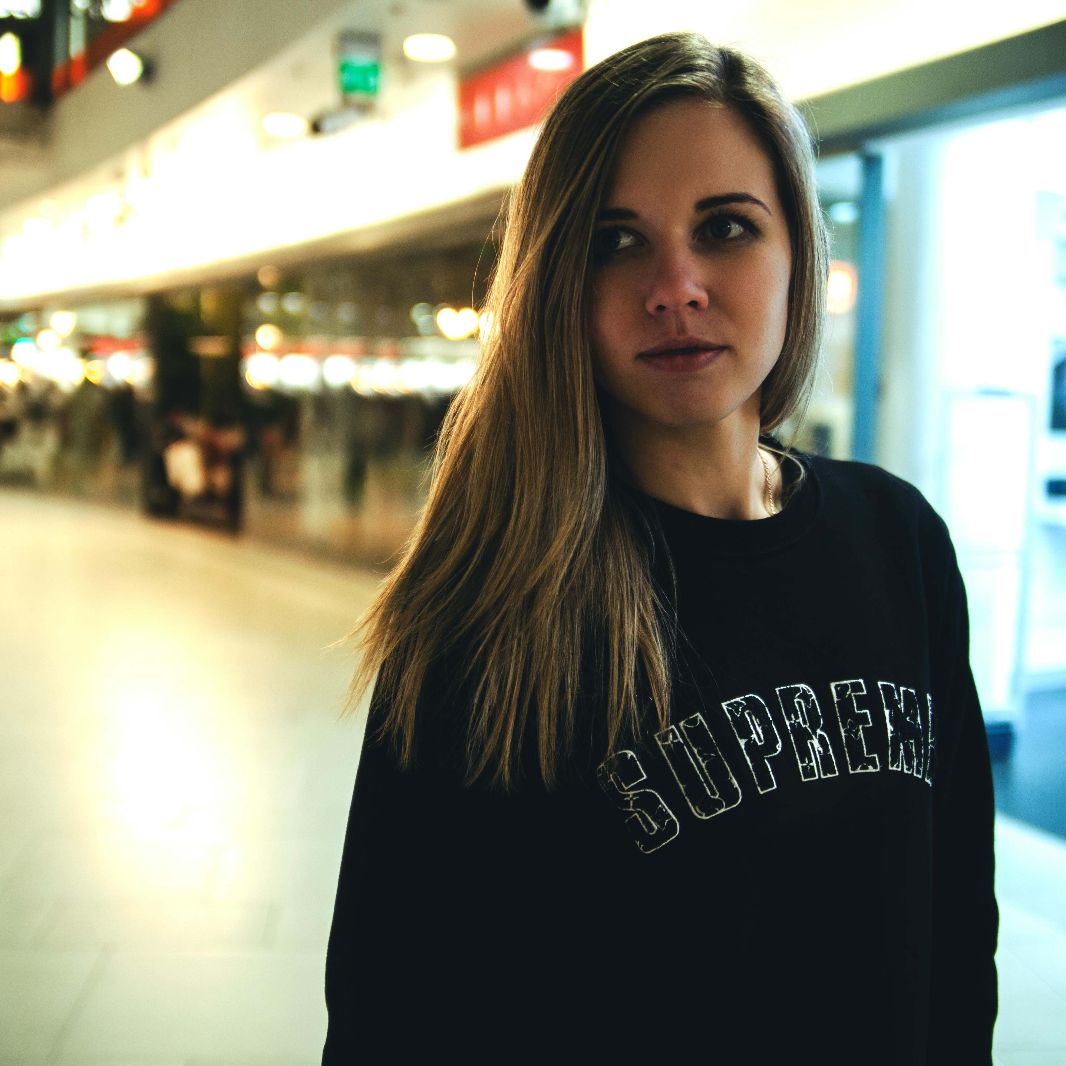 A woman looking at someone out of frame in an airport | Source: Pexels