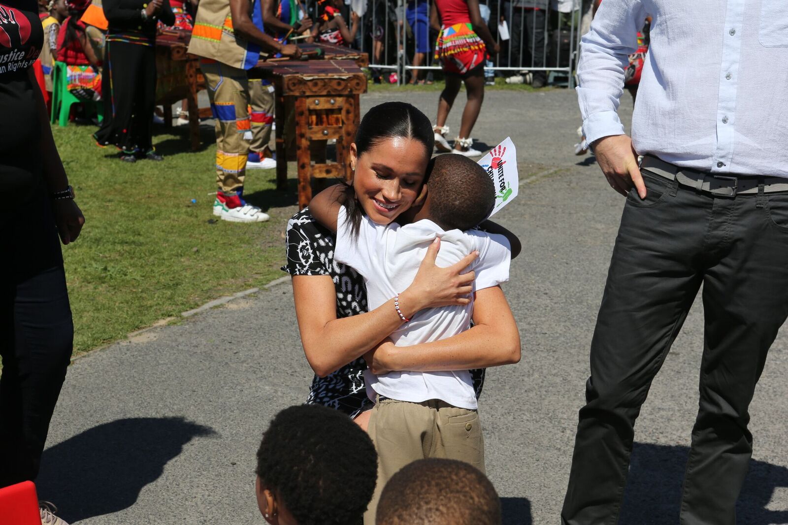 Meghan Markle hugging a child that welcomed her to South Africa | Source: Getty Images/GlobalImagesUkraine
