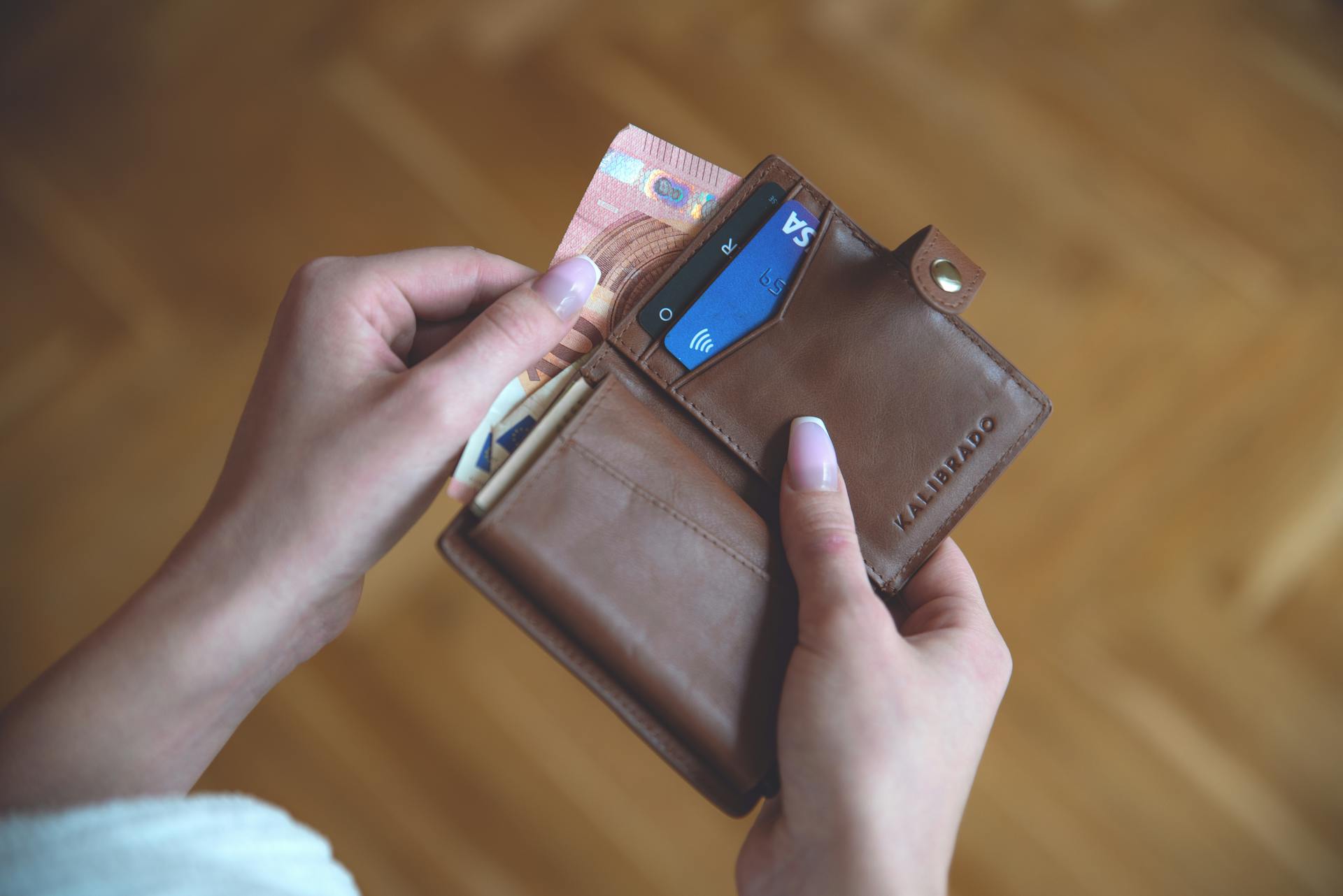 A woman holding her wallet | Source: Pexels