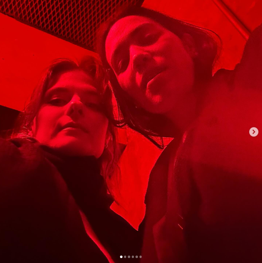 Louisa Jacobson and Anna Blundell pose under red lighting in June 2024. | Source: Instagram/louisa_jacobson
