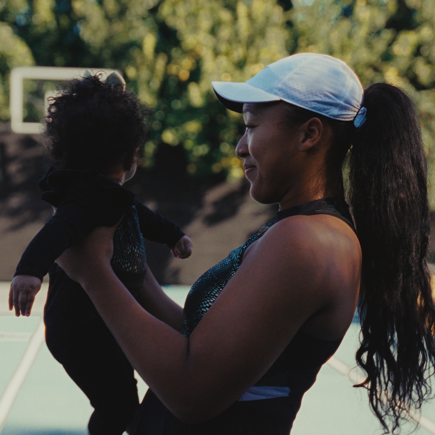Naomi Osaka holding her daughter as she looks at her with love, posted on January 1, 2025. | Source: Facebook/Naomi Osaka 大坂なおみ﻿