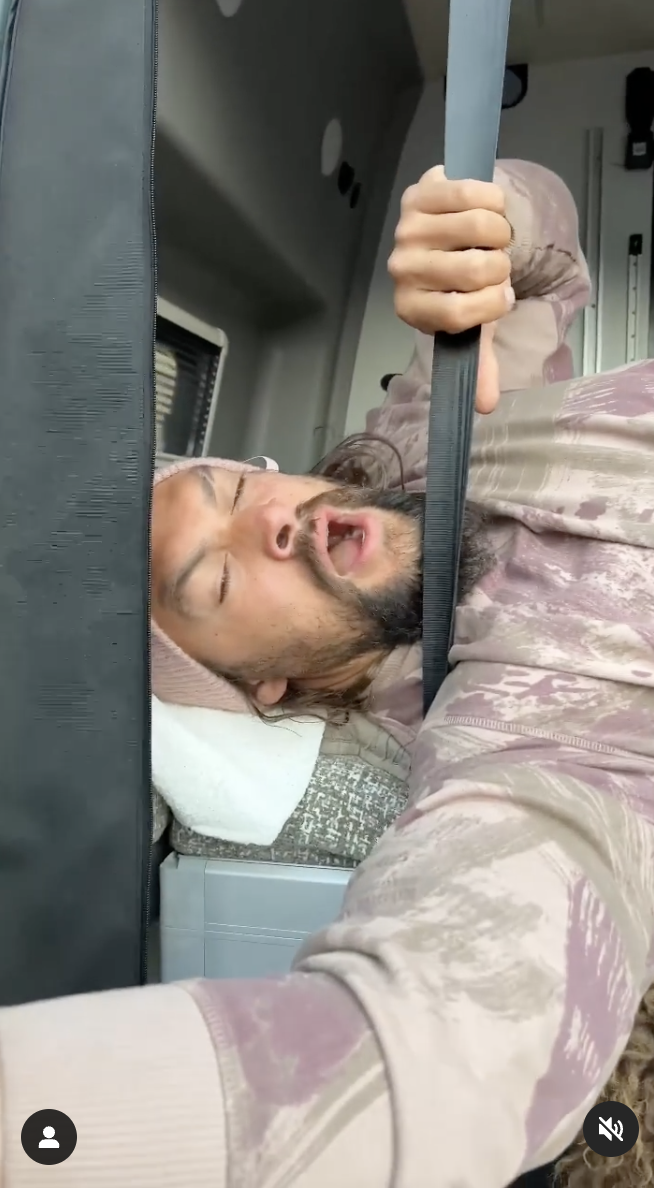 Jason Momoa is pictured yawning while lying inside his van. | Source: instagram.com/prideofgypsies/