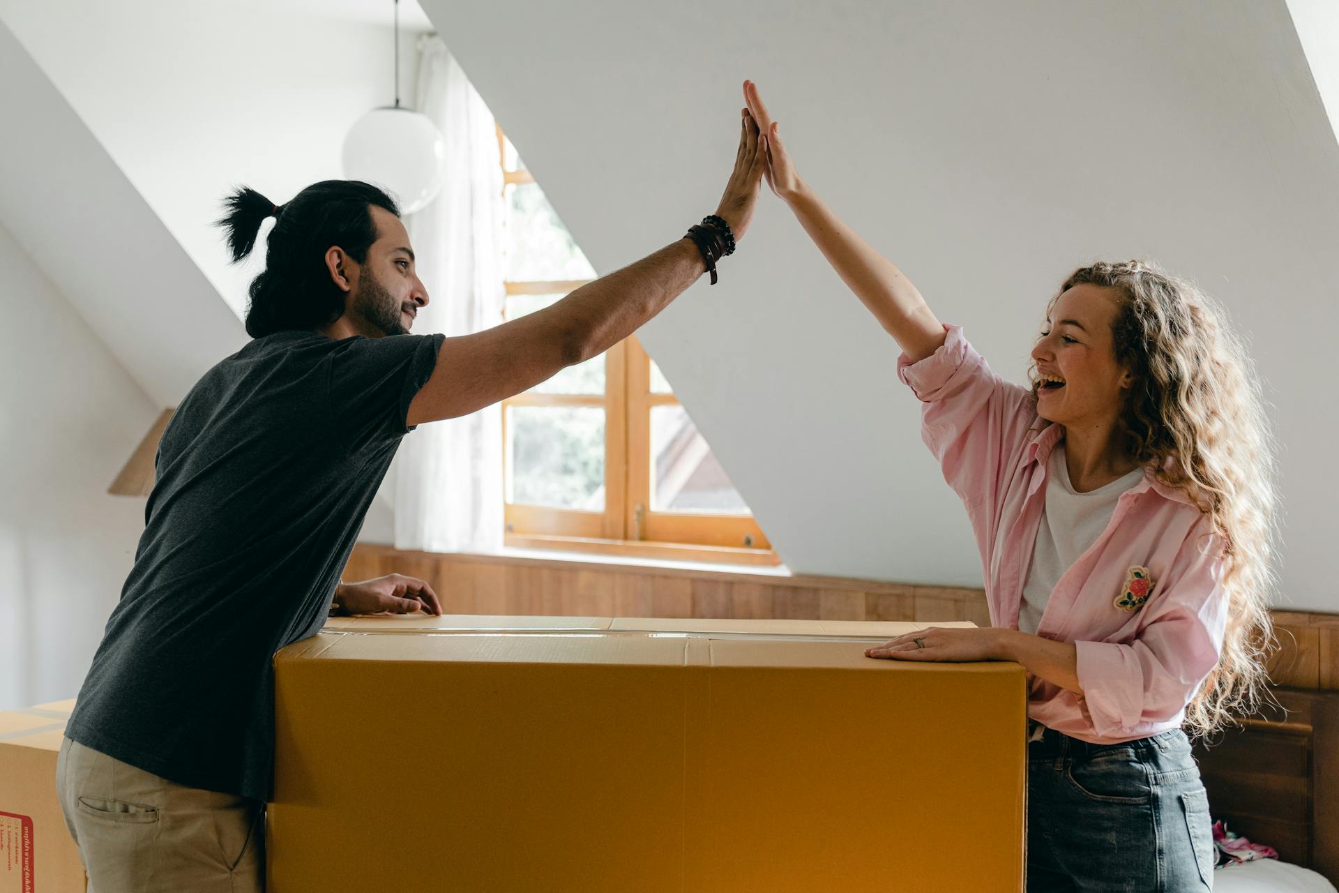 Two people sharing a high-five | Source: Pexels