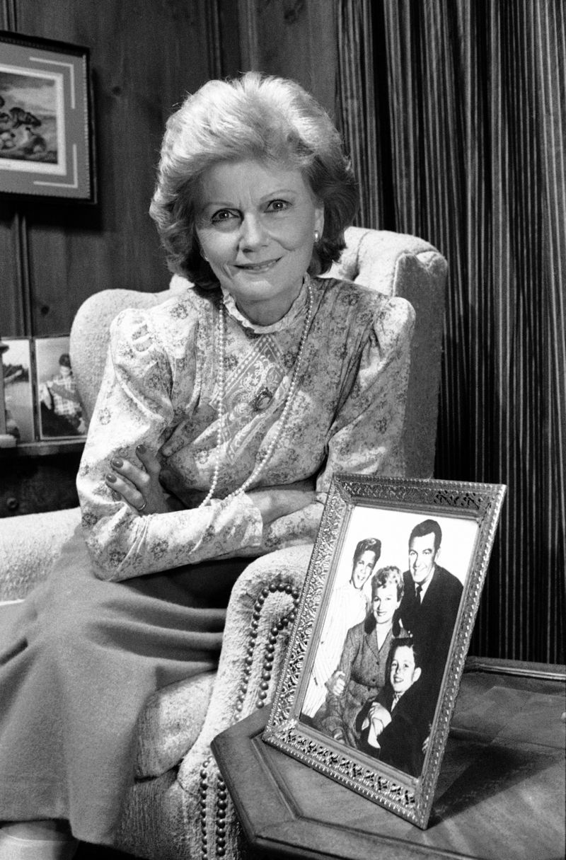 Barbara Billingsley posing with a cast photo. | Photo: Legacy.com