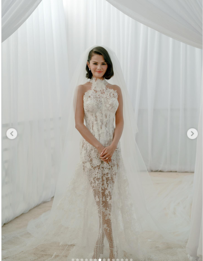 Selena Gomez poses with her legs crossed as she stuns in her lace gown, from a post dated September 30, 2025 | Source: Instagram/selenagomez