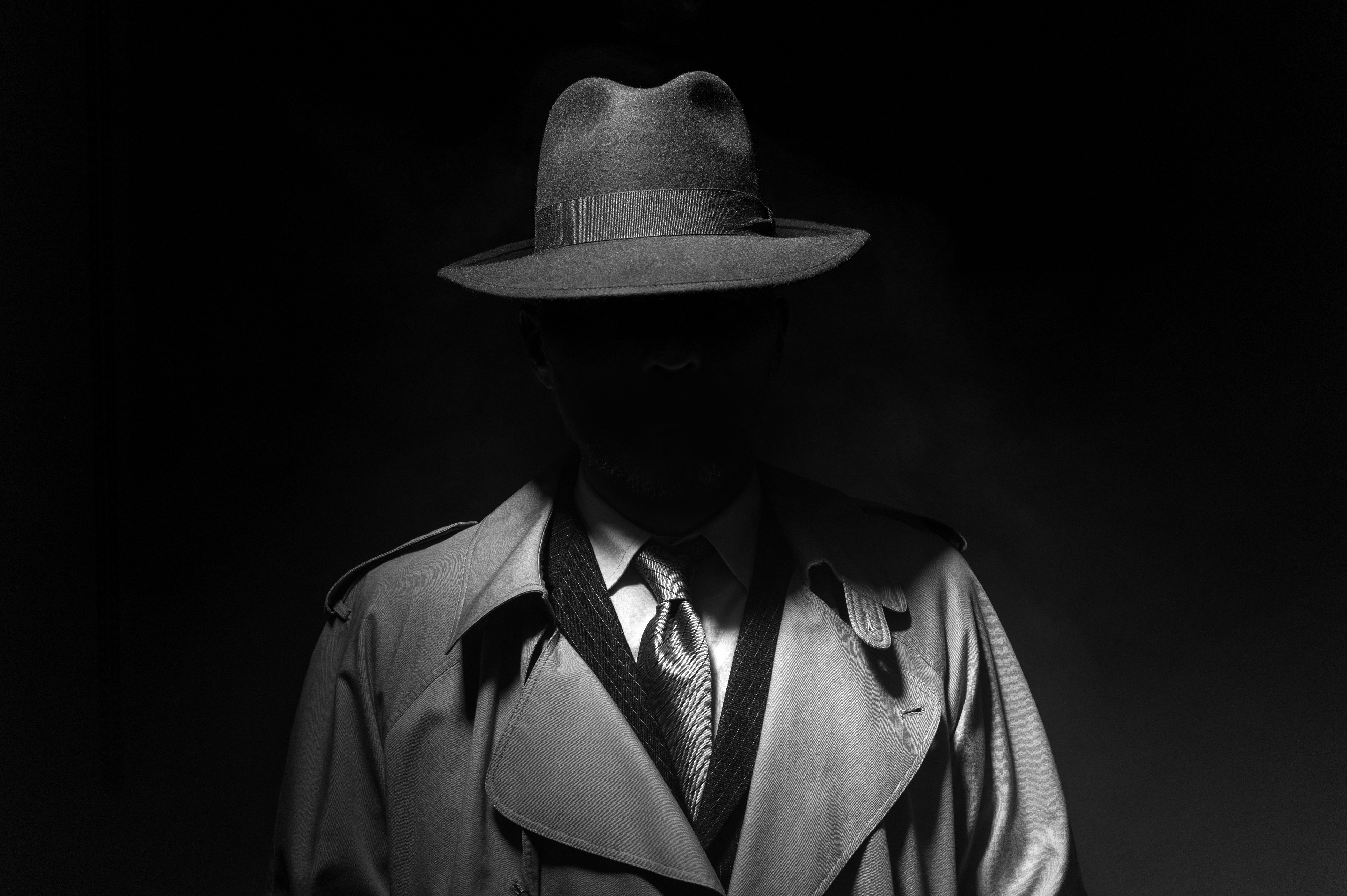 A detective standing in the shadows. │Source: Shutterstock