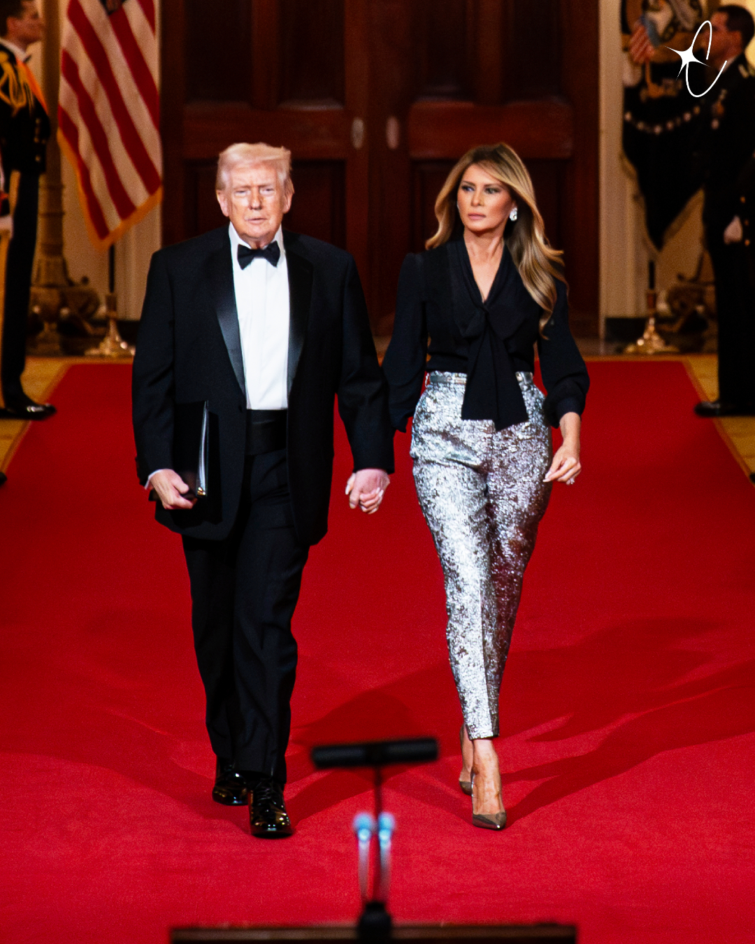 Donald Trump and Melania Trump hold hands during their National Governors Association Evening Dinner and Reception arrival in the East Room of the White House | Source: Getty Images